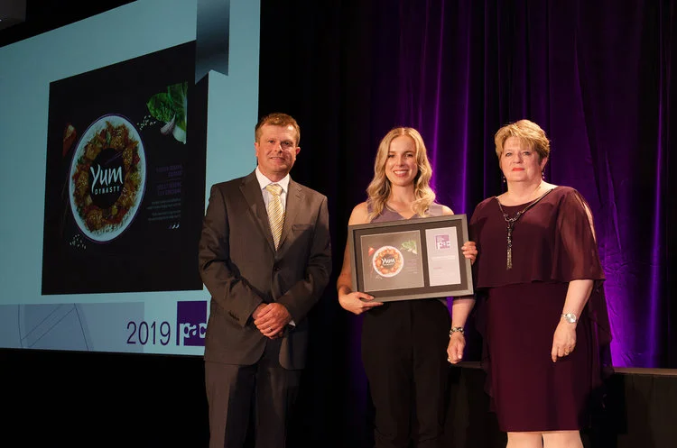 Bri-Anne Kitka, Designer, accepted the award for Yum Dynasty.
