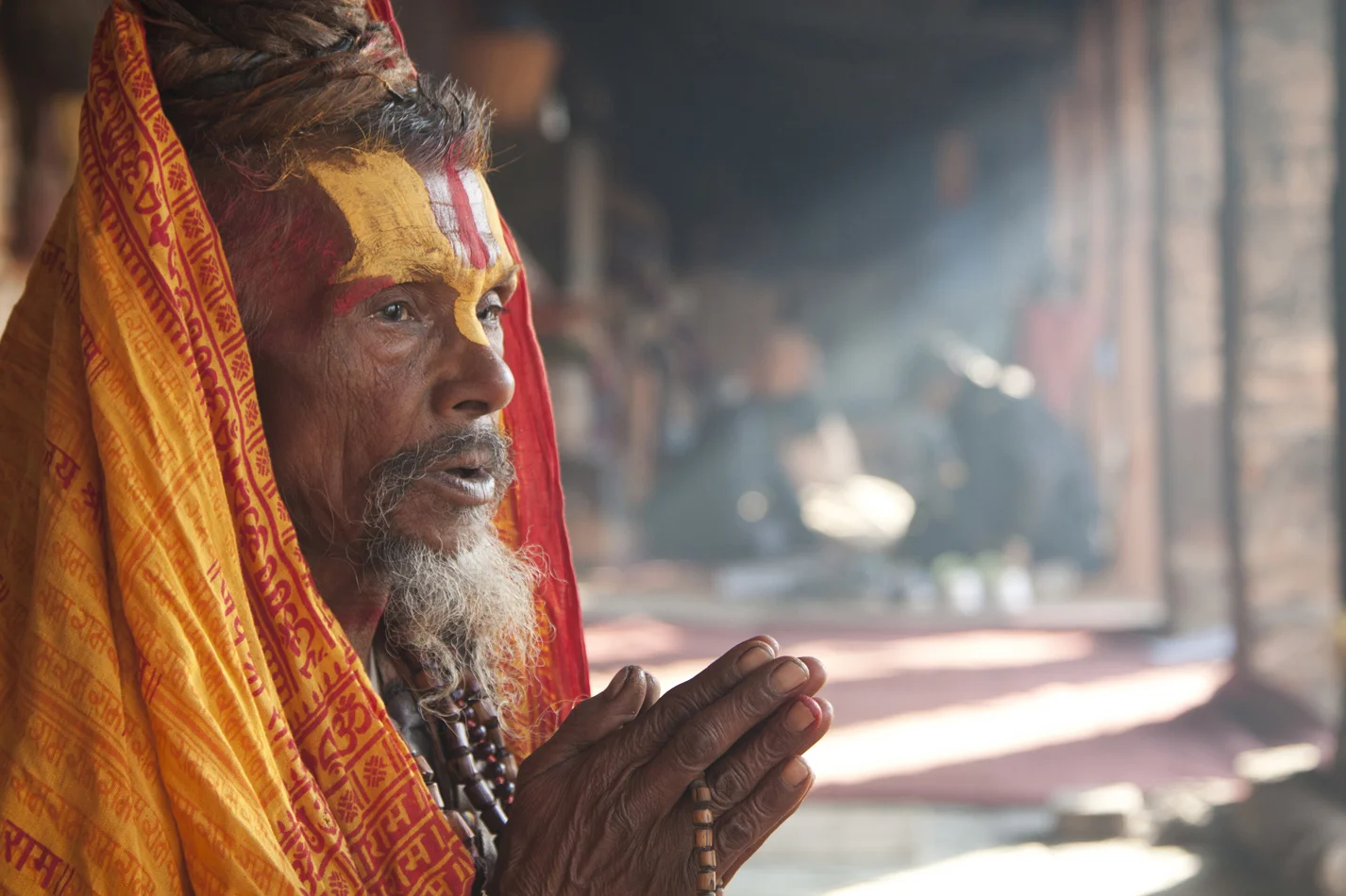 Nepal, a Sadhu near Pashupatinath temple. Pray after having paint his face. 
