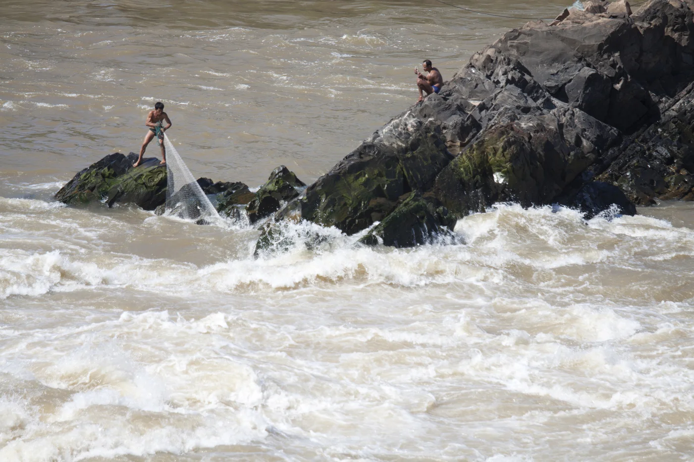 Laos, fishermans at the Mekong river. 