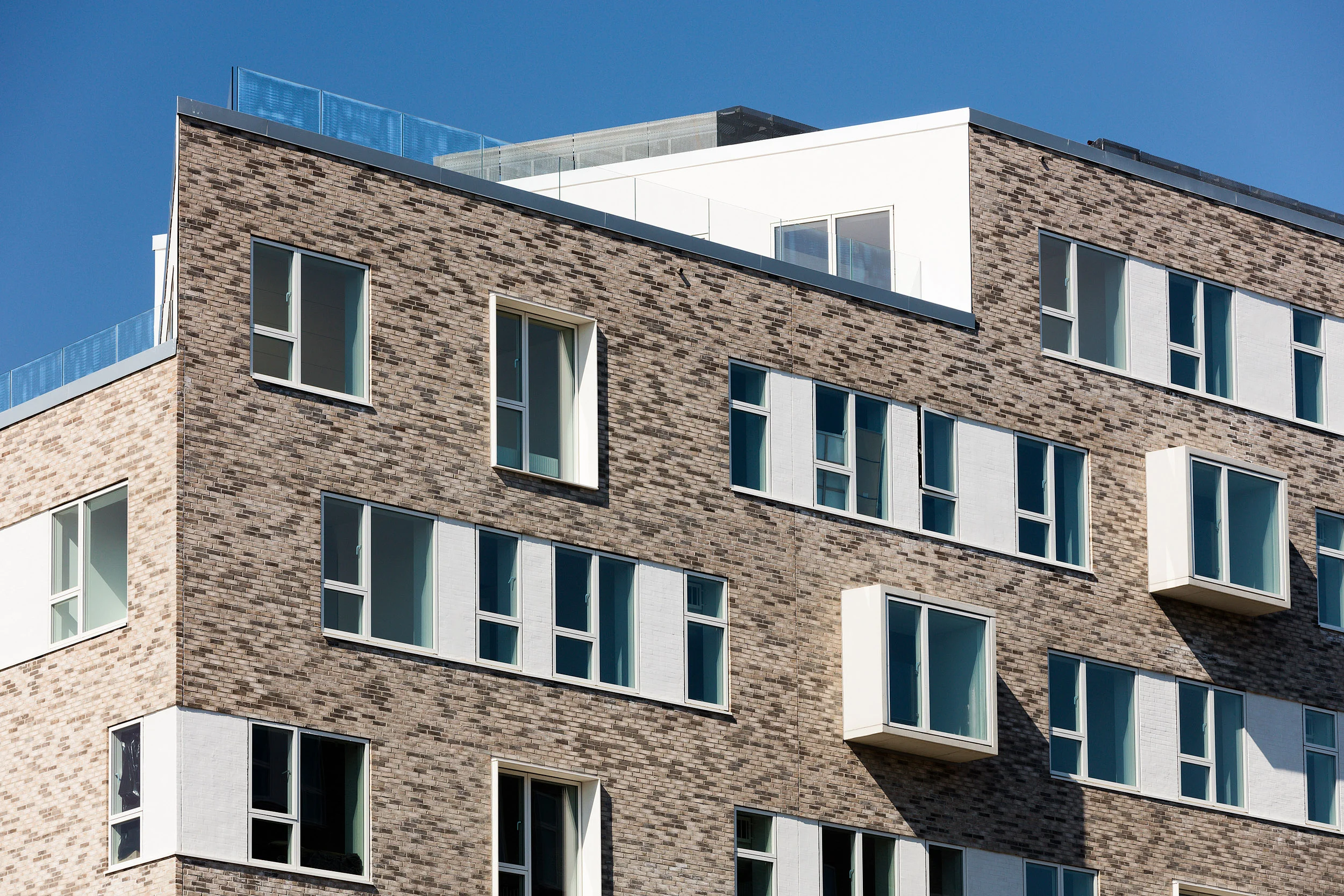 Residential housing, Skibbroen, realised by Holscher Nordberg Architects. Photographed from early morning throughout the day, letting the sun emphasise the various aspects of the buildings character. The special life that characterizes Skibbroen occurs due to users’ various activities and the mix of tranquility, activity, transit and practical doings.The uniqueness of the channel and harbor space is maintained. Photographed from early morning throughout the day, letting the sun emphasise the various aspects of the buildings character. 