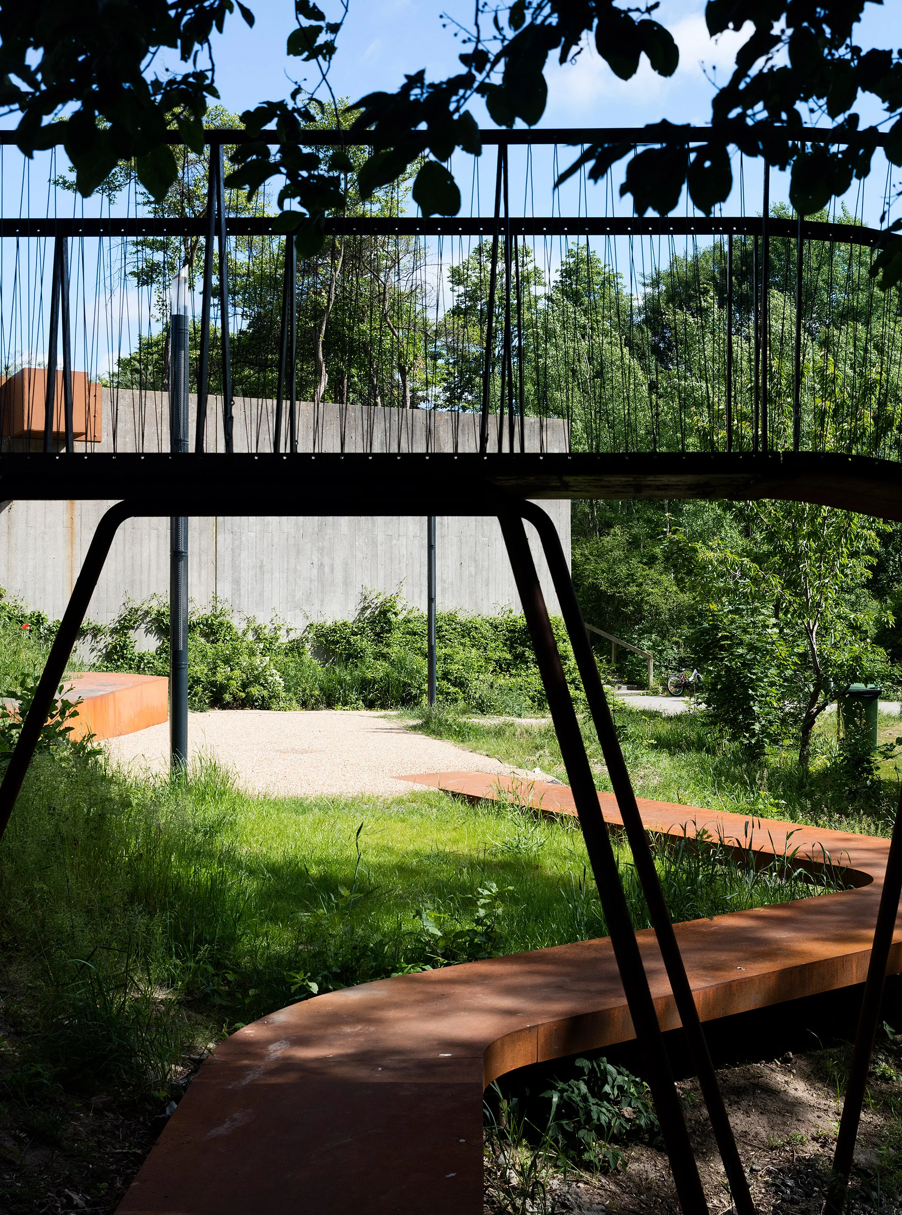 The Loop, realised by Holscher Nordberg Architects Værebro Park, a residential area in the suburbs of Copenhagen, has in the last years suffered from high crime rates and a declining number of inhabitants. Placed in the intersection between an indoor swimming pool, a primary and secondary school, and the 1400 dwellings of Værebro Park, the activity path aims to create a physical and mental bridge between the different users of the area. The low budget yet esthetical element is designed as a playful path offering a variation of activities.