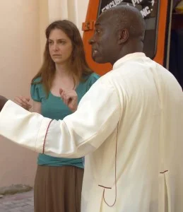 Dr. Gabriella Nanci and Msgr Simon Assamoah loading a van with medical supplies.