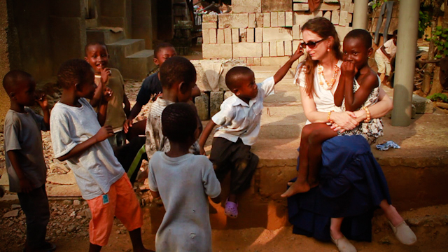 Dr. Gabriella Nanci with children during a malaria screening campaign