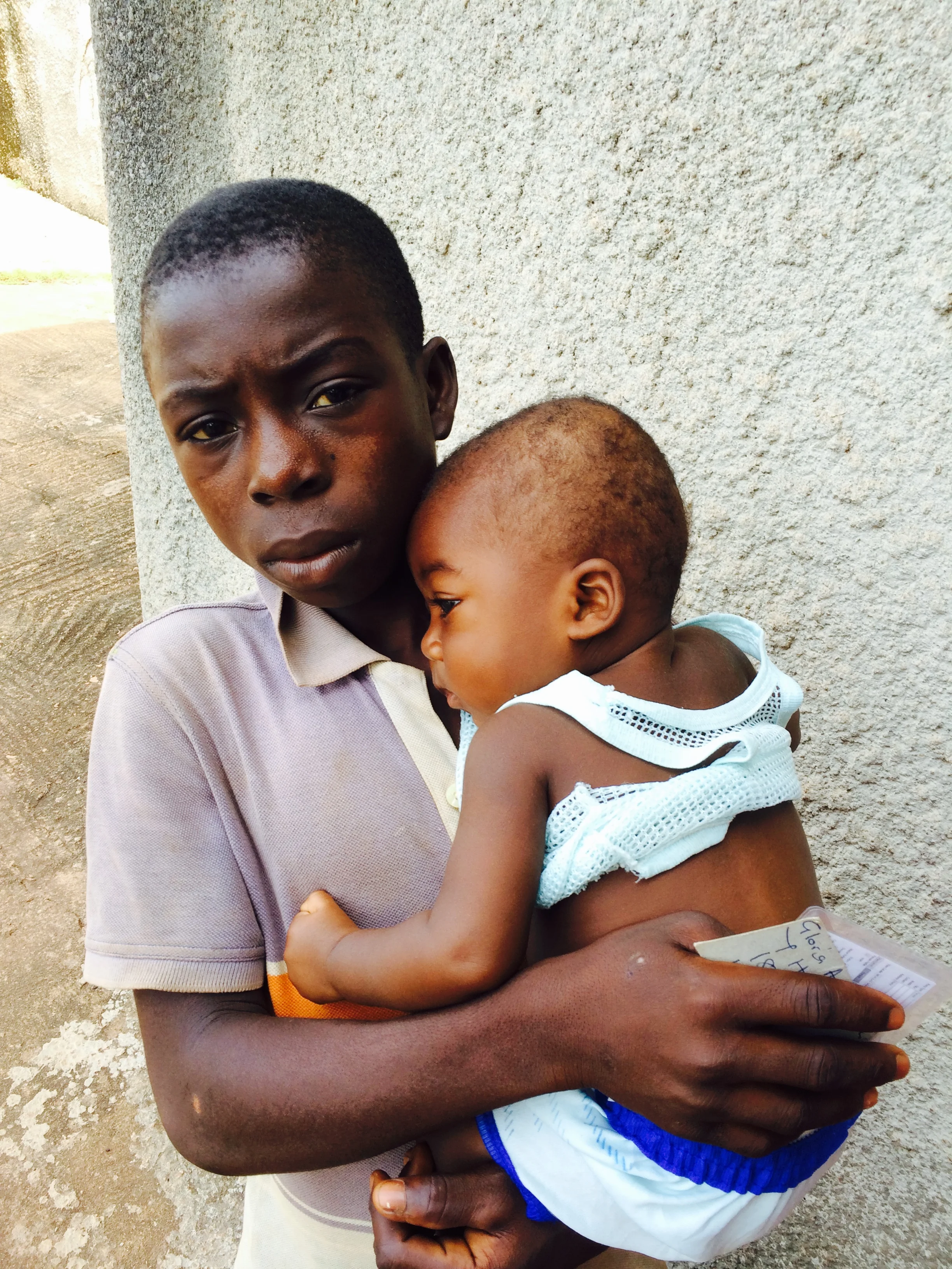 This concerned young man brought his baby brother for treatment of a severe ear infection, malaria, and pneumonia. Malaria and pneumonia are the top killers of children under five years of age in Western Africa.