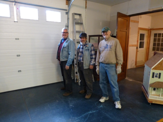 Volunteers Scot McCollum, George Italiano and Bob Mullen in the garage at West Ave where large artifacts will be stored.