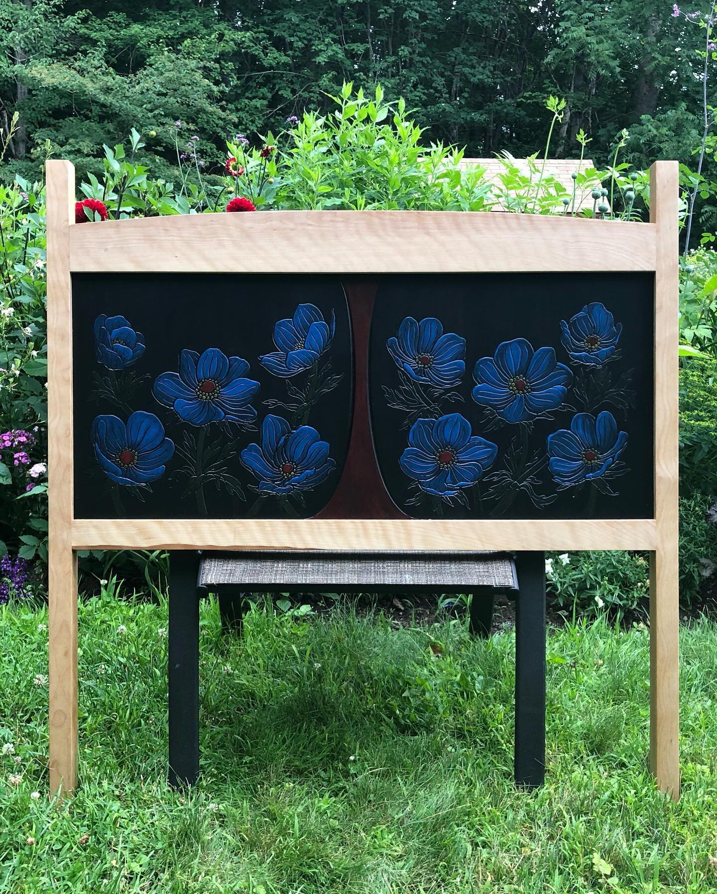 I made a twin-sized headboard! Maple rails and posts. The panel is MDF. I drew the flowers, scanned them into the computer and then my awesome husband used the CNC router in our basement to carve them out. I then painted the flowers with acrylic pain