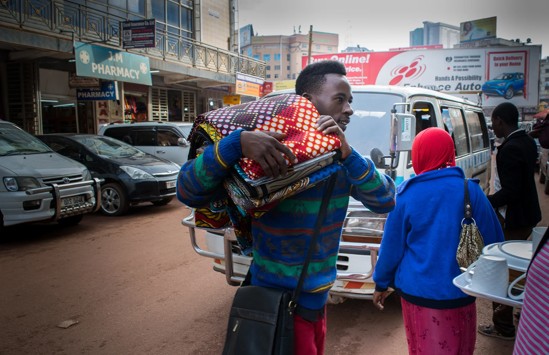 A1_Elvis carrying Kitenge from his sisters shop to restock.jpg