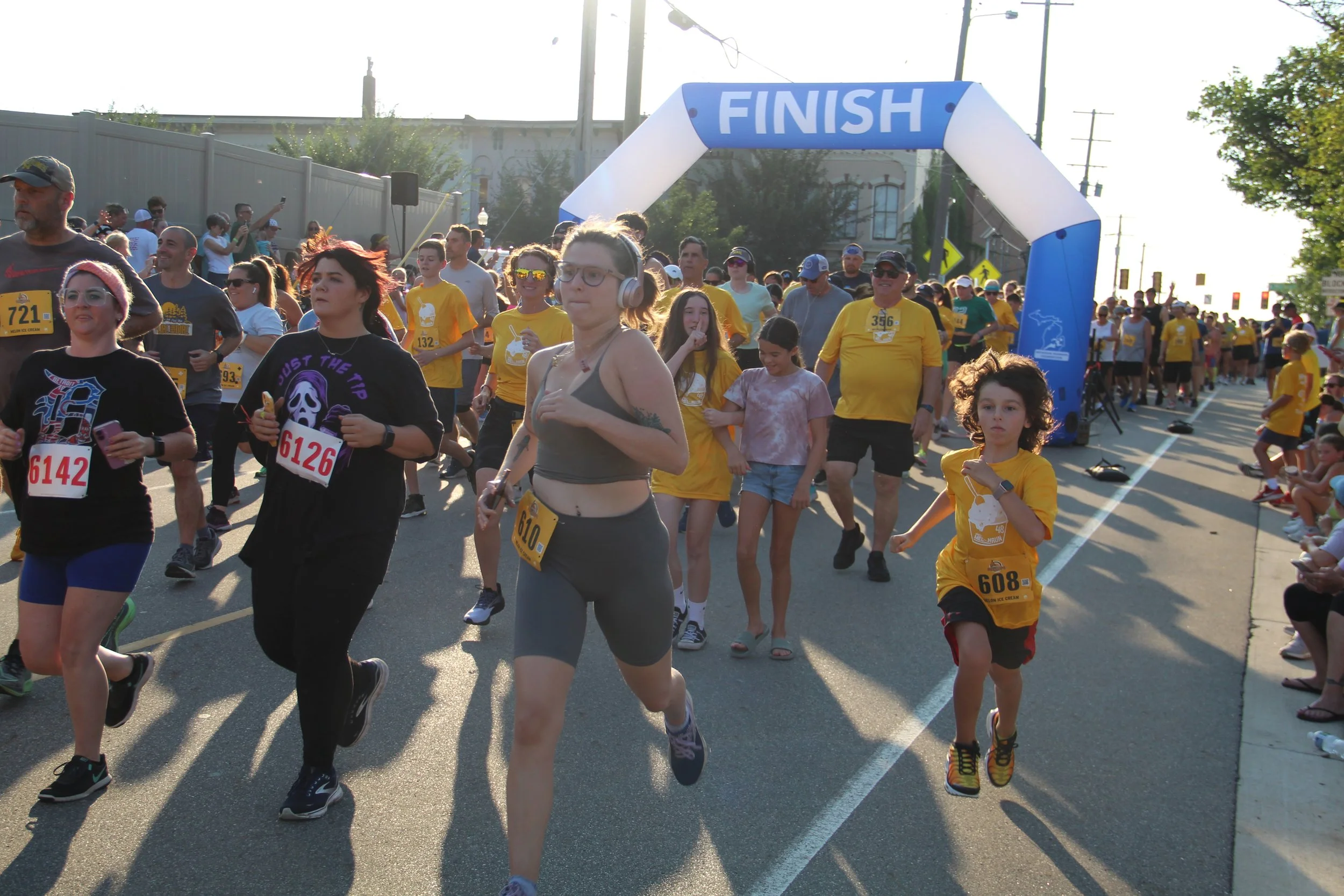 A group of runners dash from the starting line at the 2025 Howell Melon Run.