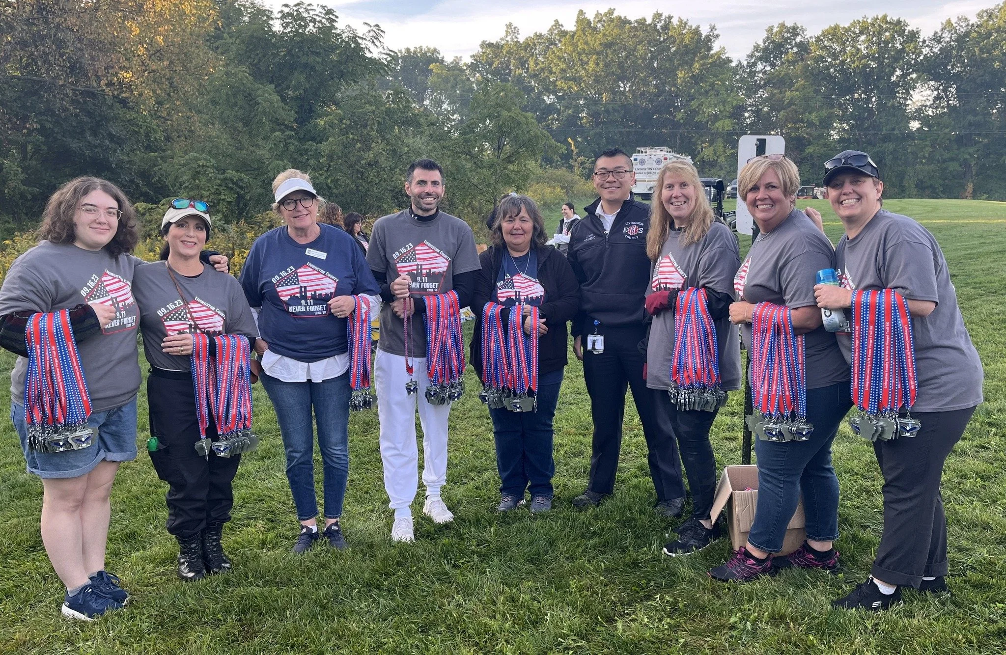 Volunteers pass out medals at the Never Forget Trail 5K.