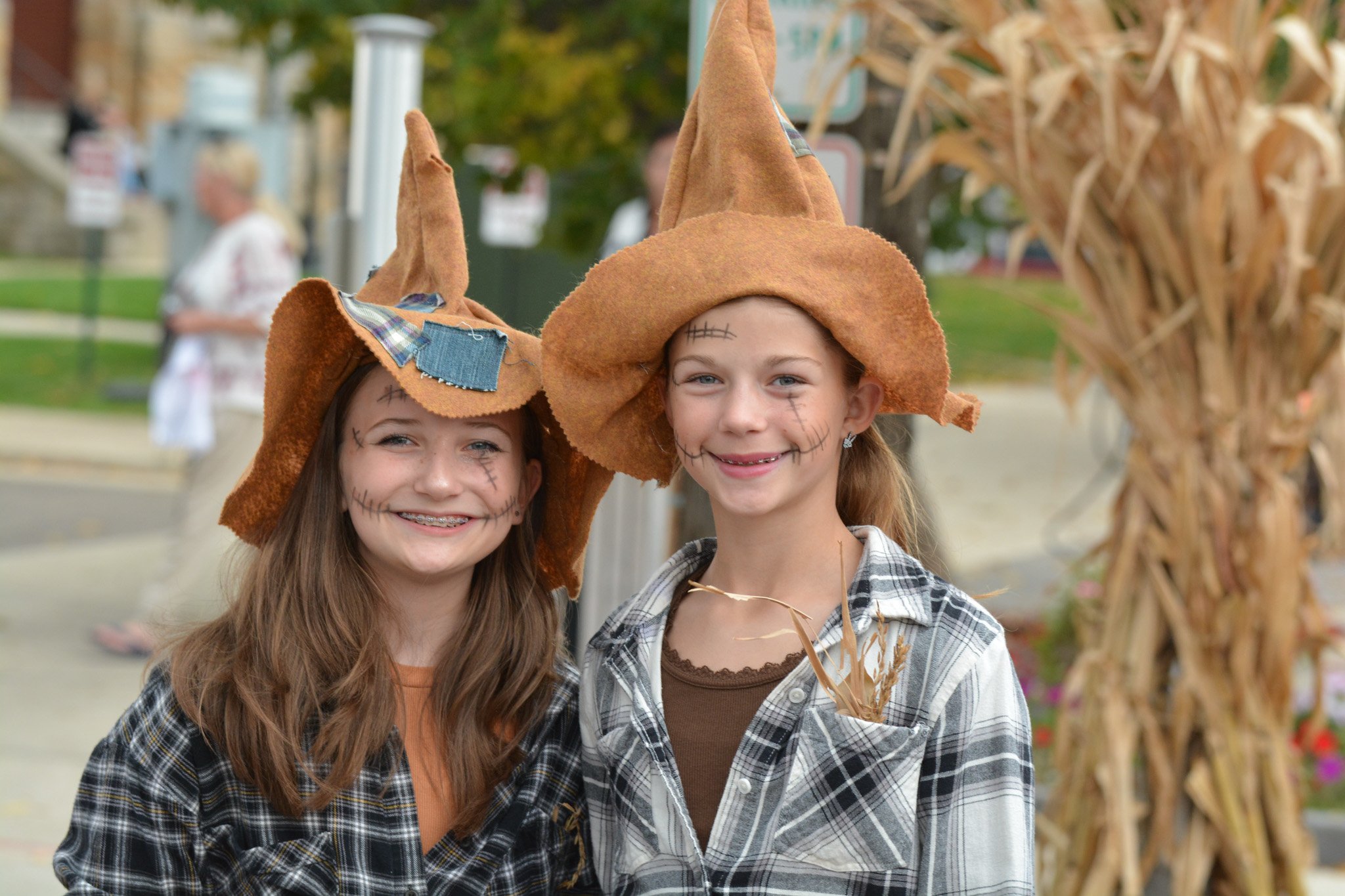 Two girls dressed as scarecrows smile at the 2025 Legend of Sleepy Howell.
