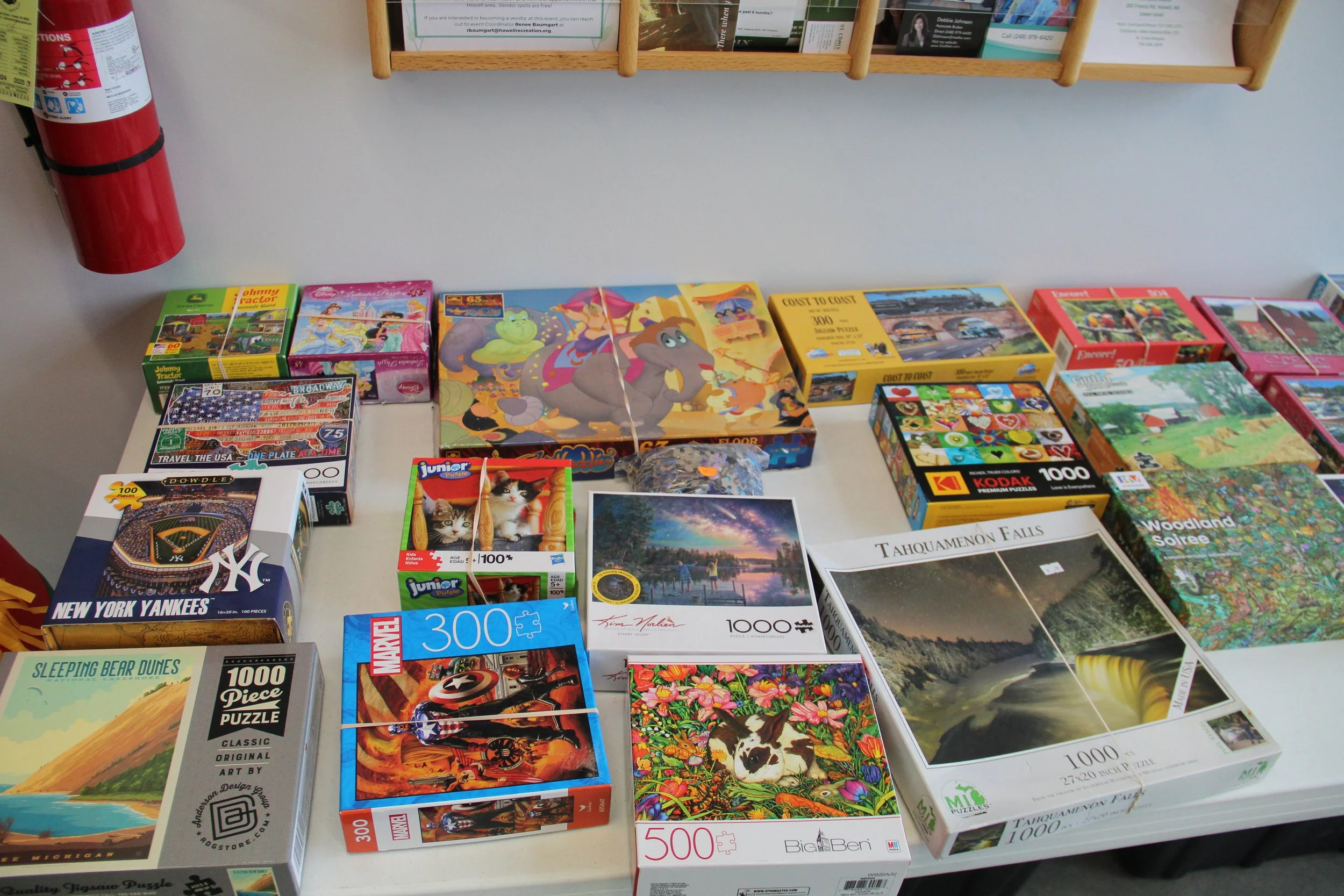 A collection of colorful jigsaw puzzles sit on a table.