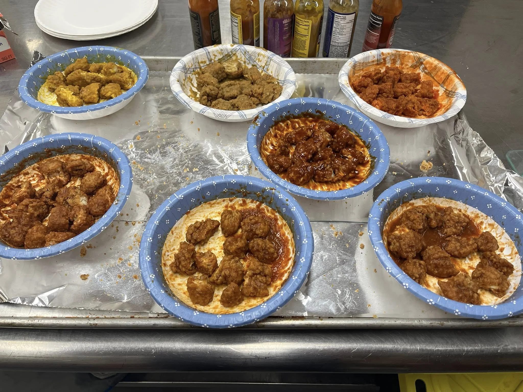 A variety of wings and hot sauces.