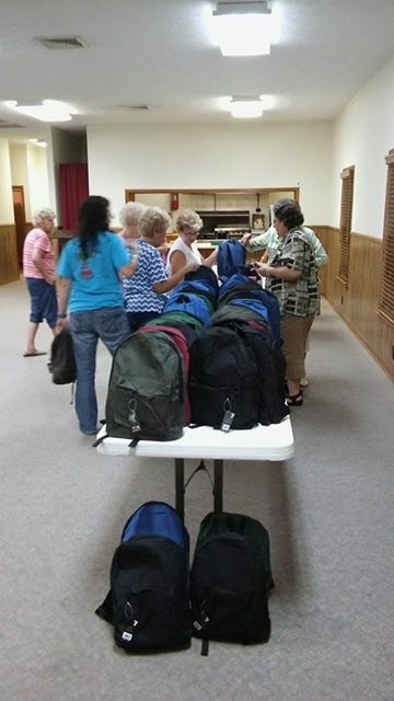 WOM putting together backpacks for Appalachia.