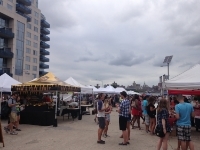 Smorgasburg- a parking lot of delicacies, with the backdrop of condominiums 