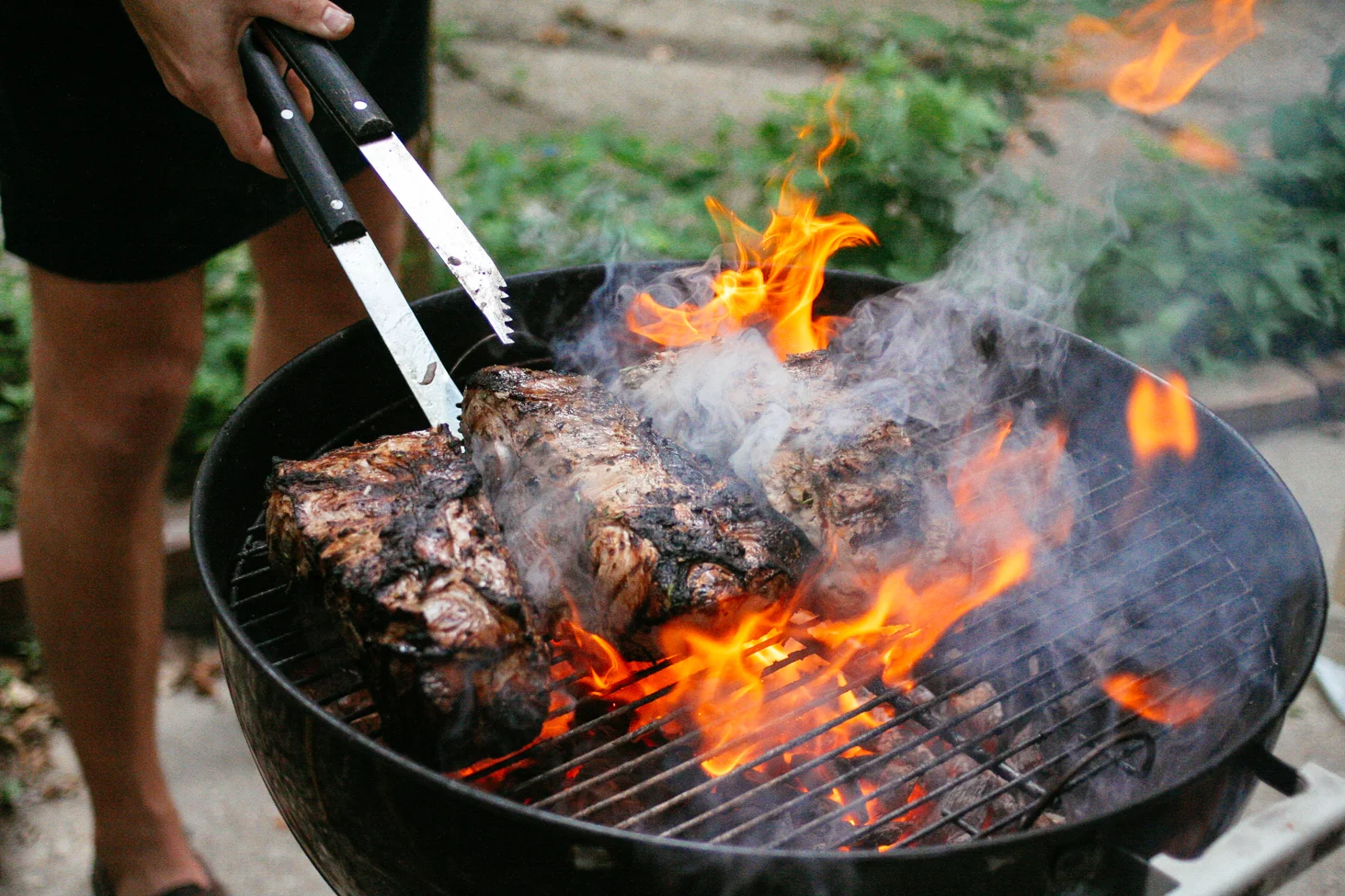 Charring pork shoulders.