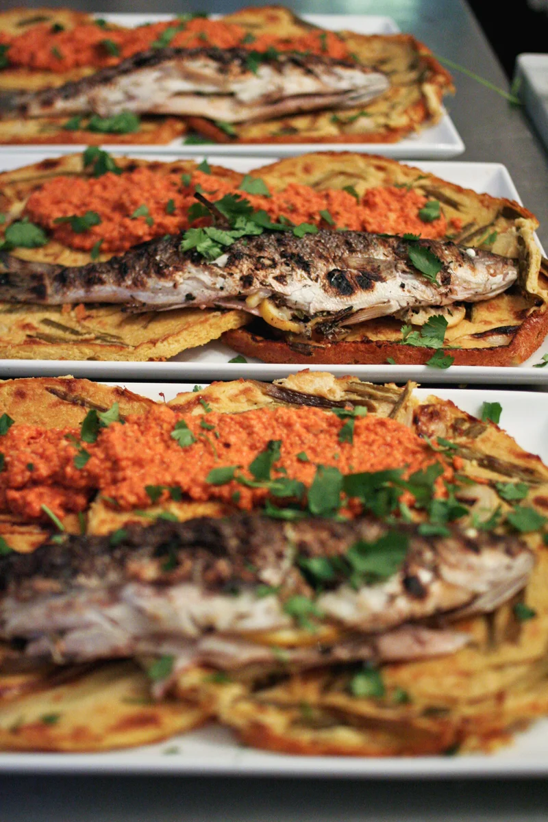 Grilled Bronzini, Spring Onion Farinata, Romesco Sauce