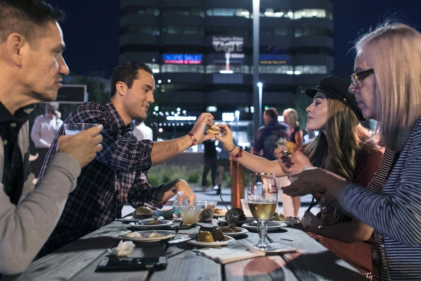 Alejandro Girron, left, Jonathan Schoeman, Alexa Girron and Teresa Girron sample the food and drinks during the second night of the L.A. Times' The Taste OC on Saturday. (Silvia Razgova / For The Times)