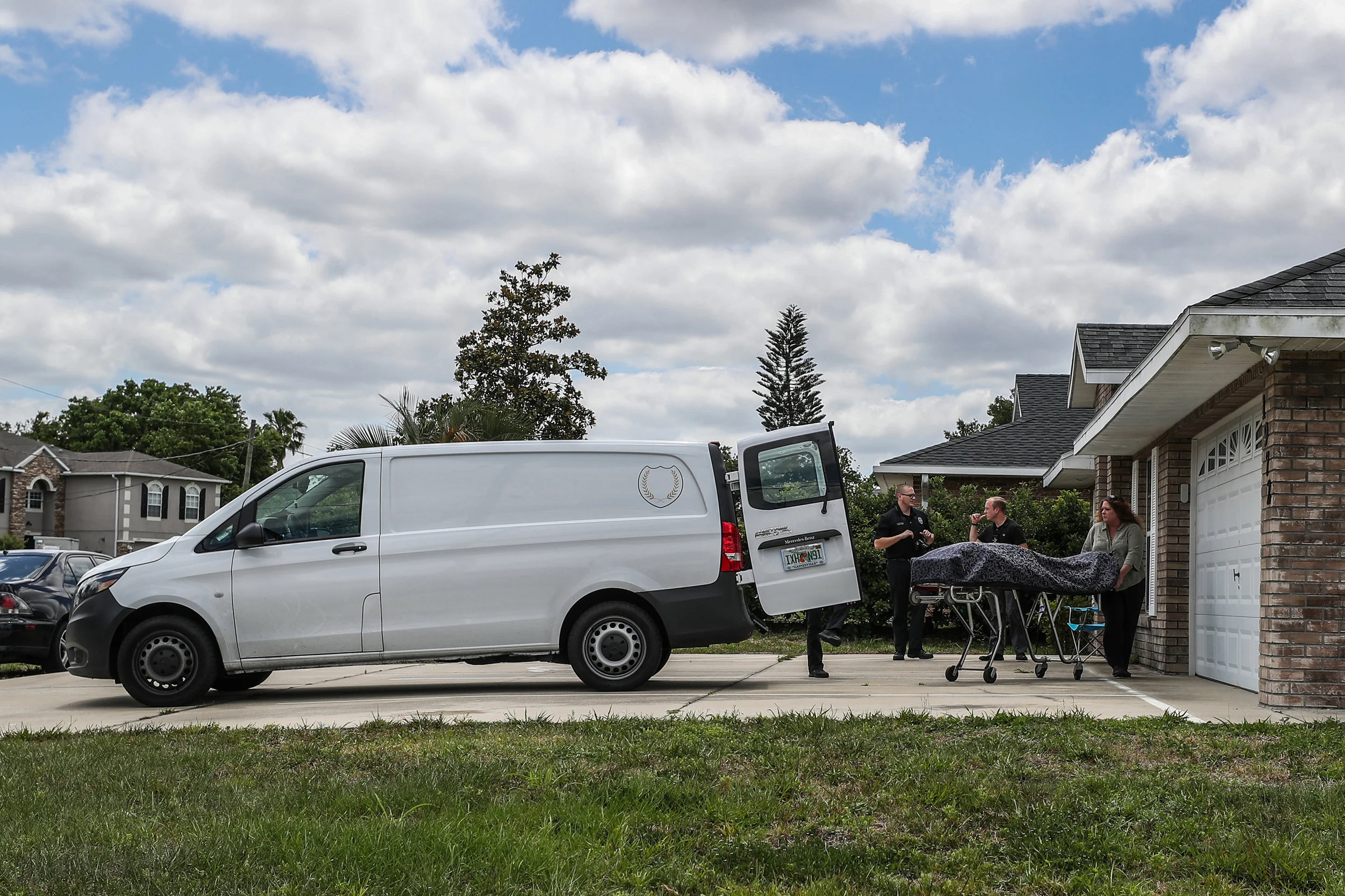 Medical examiners prepare to load the body of overdose victim Gerald Frank Farmer into a waiting livery van. Farmer was prescribed narcotics following a car accident and had a history of substance abuse, Volusia County Sheriff's Office investigators said. Deltona on Wednesday, May 2, 2018.