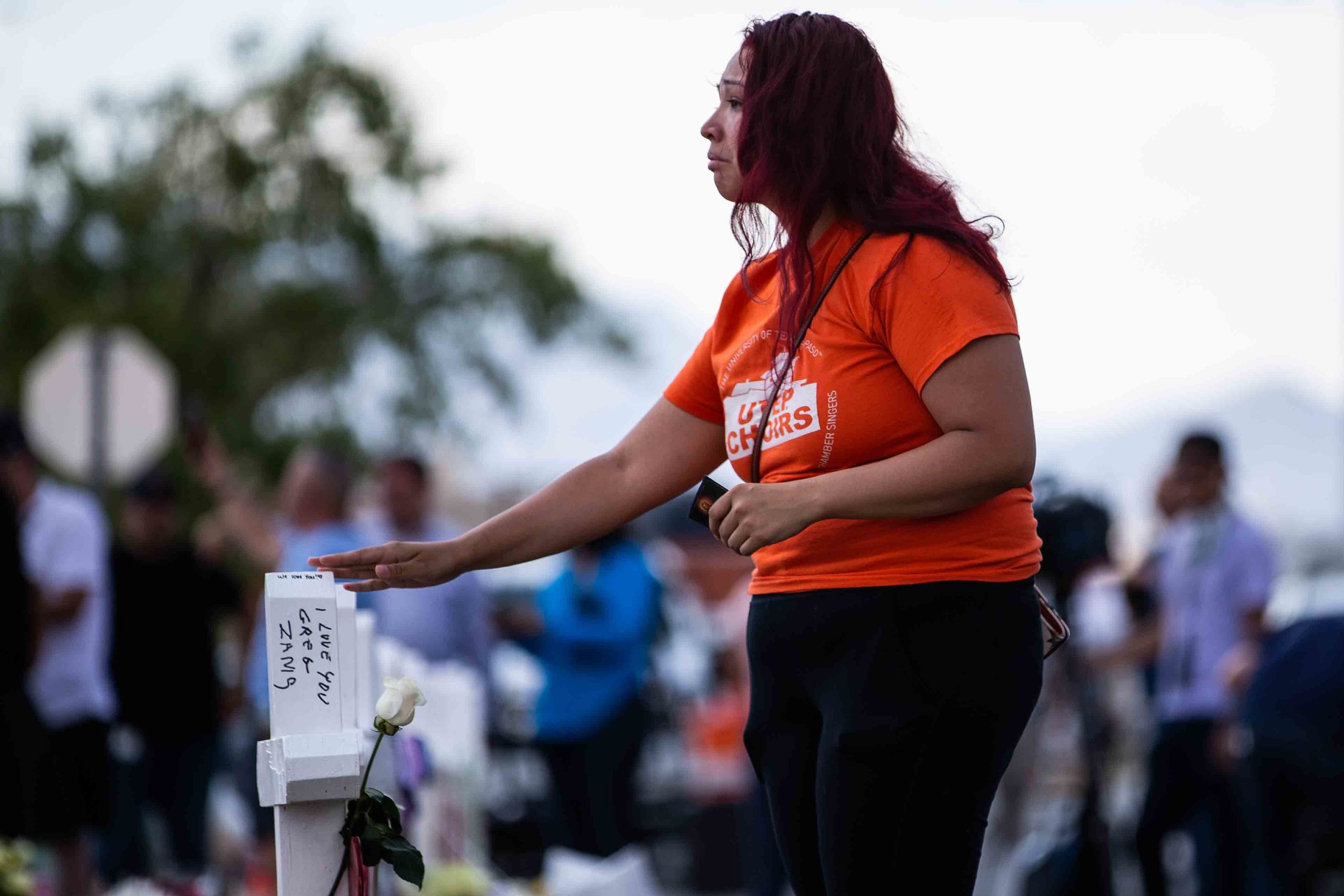  A woman approaches the crosses with the names of the victims of the mass shooting occurred in Walmart last Saturday morning have been placed on the scene to honor their memory in El Paso on Monday, August 5, 2019. 