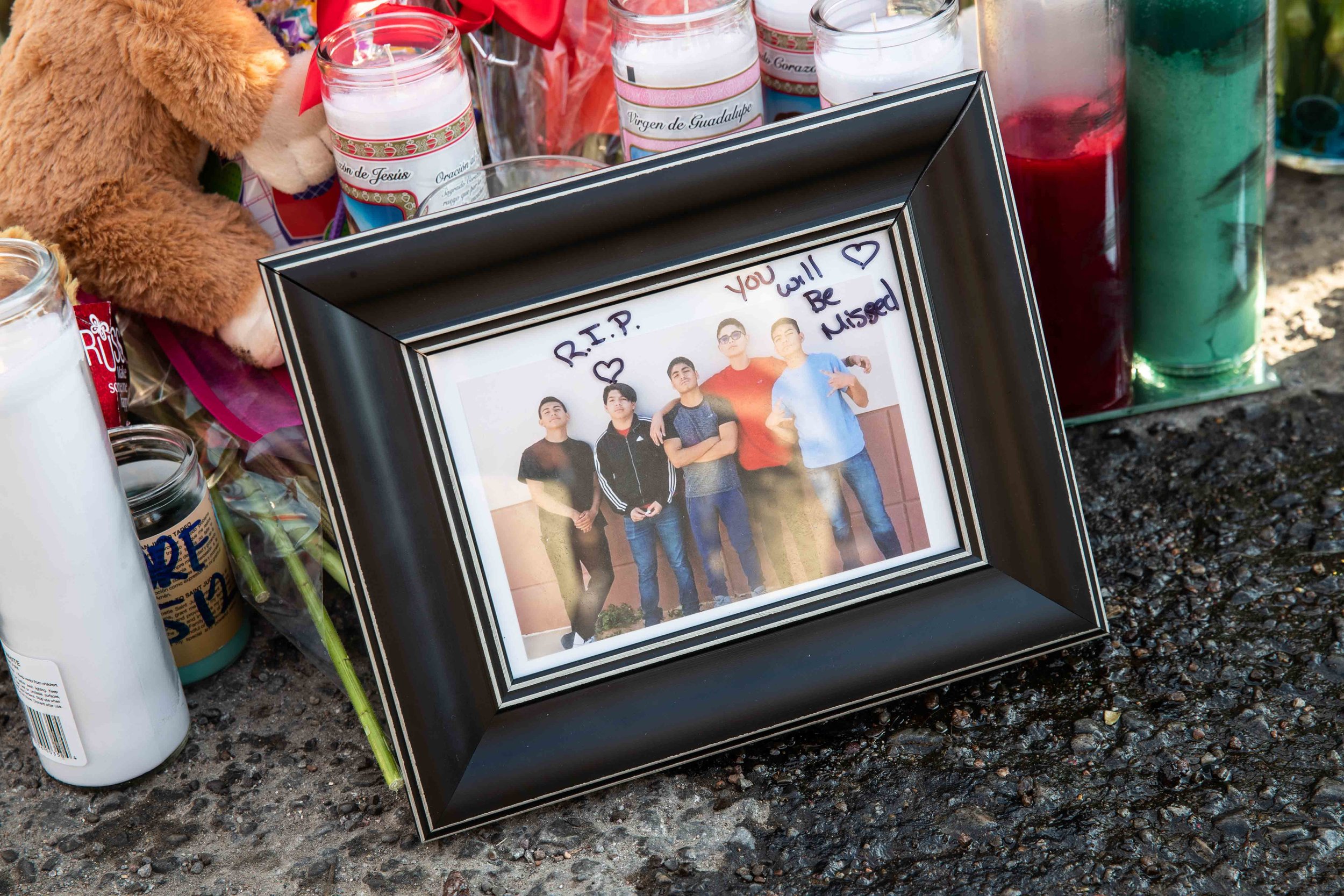  A photo of Javier Rodriguez posing with his friends is placed on the scene to honor his memory in El Paso on Monday, August 5, 2019. 