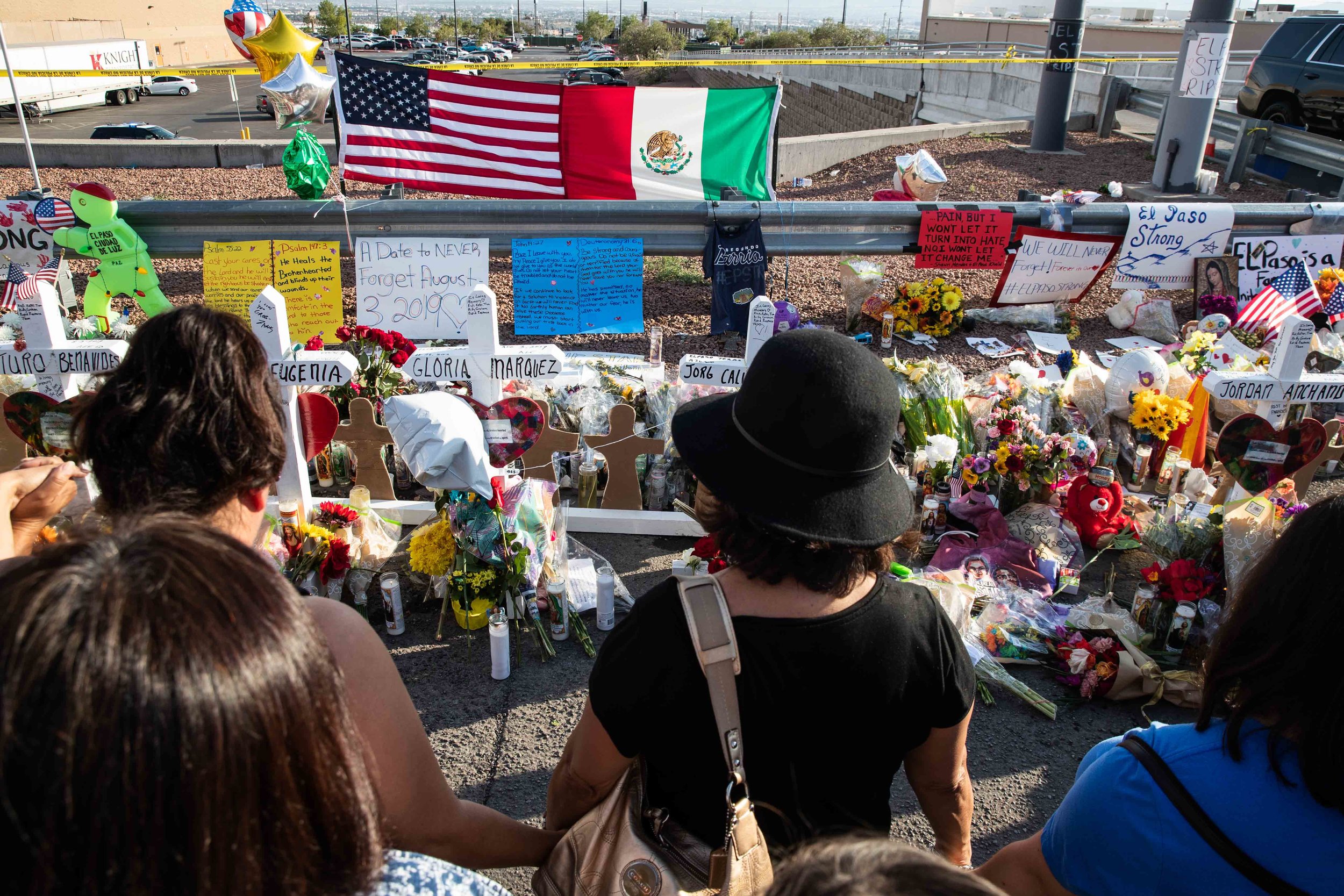  Pleople gather near the scene where crosses with the names of the victims of the mass shooting occurred in Walmart last Saturday morning have been placed to honor their memory in El Paso on Monday, August 5, 2019. 