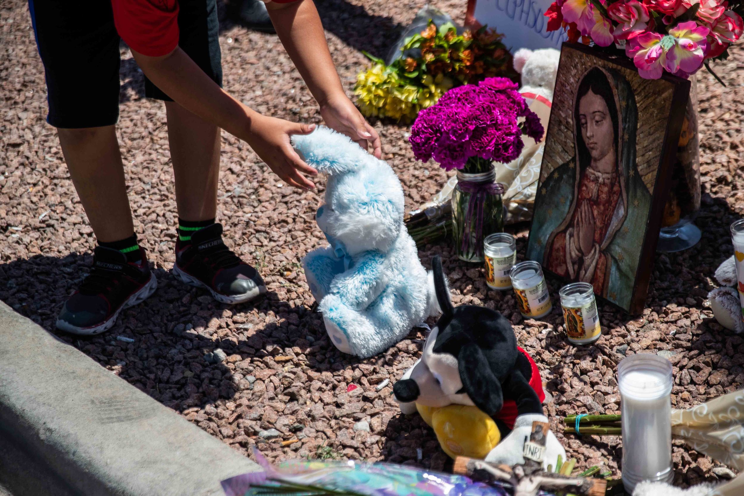  Kevin Roldan leaves a stuffed animal next to a Virgen de Guadalupe poster to honor the memory of the victims of the mass shooting occurred in Walmart on Saturday morning in El Paso on Sunday, August 4, 2019. 