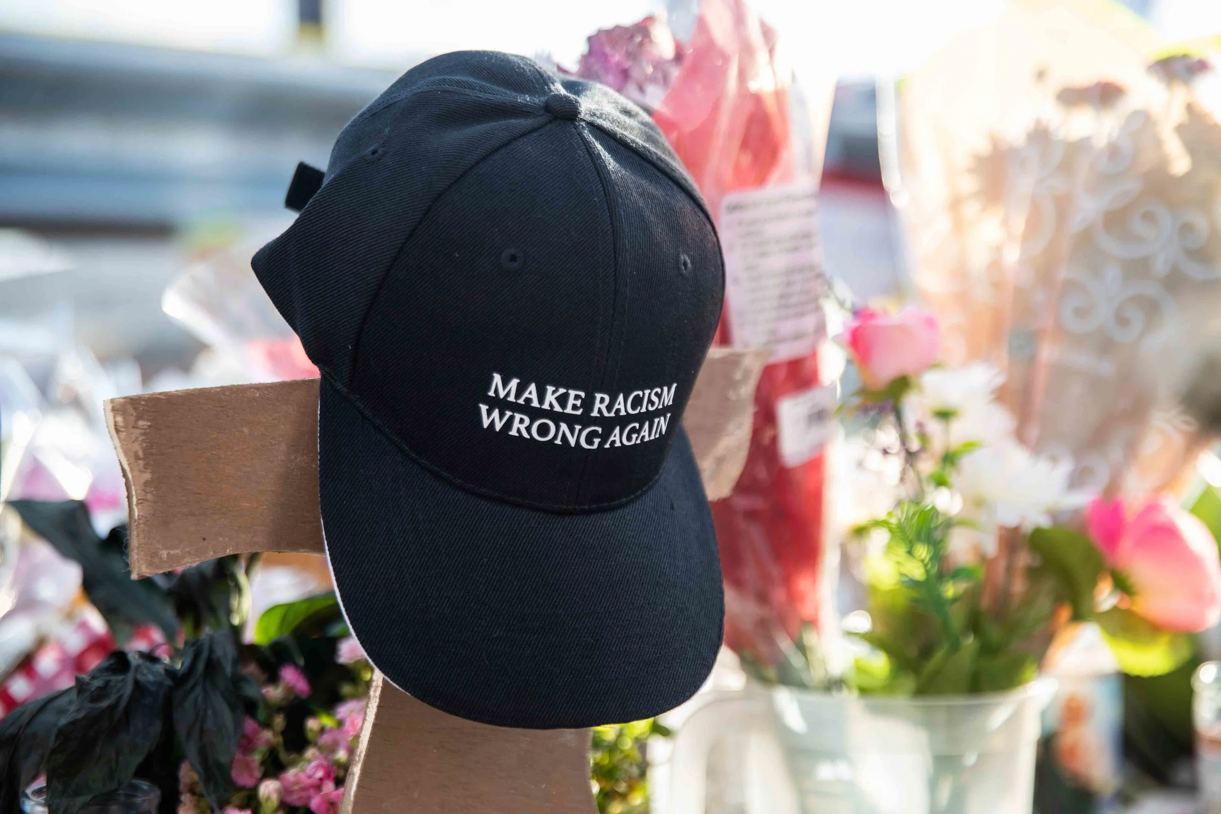 A cap with "MAKE RACISM WRONG AGAIN" is placed at the scene where a mass shooting occurred in Walmart last Saturday morning to honor victims' memory in El Paso on Monday, August 5, 2019.