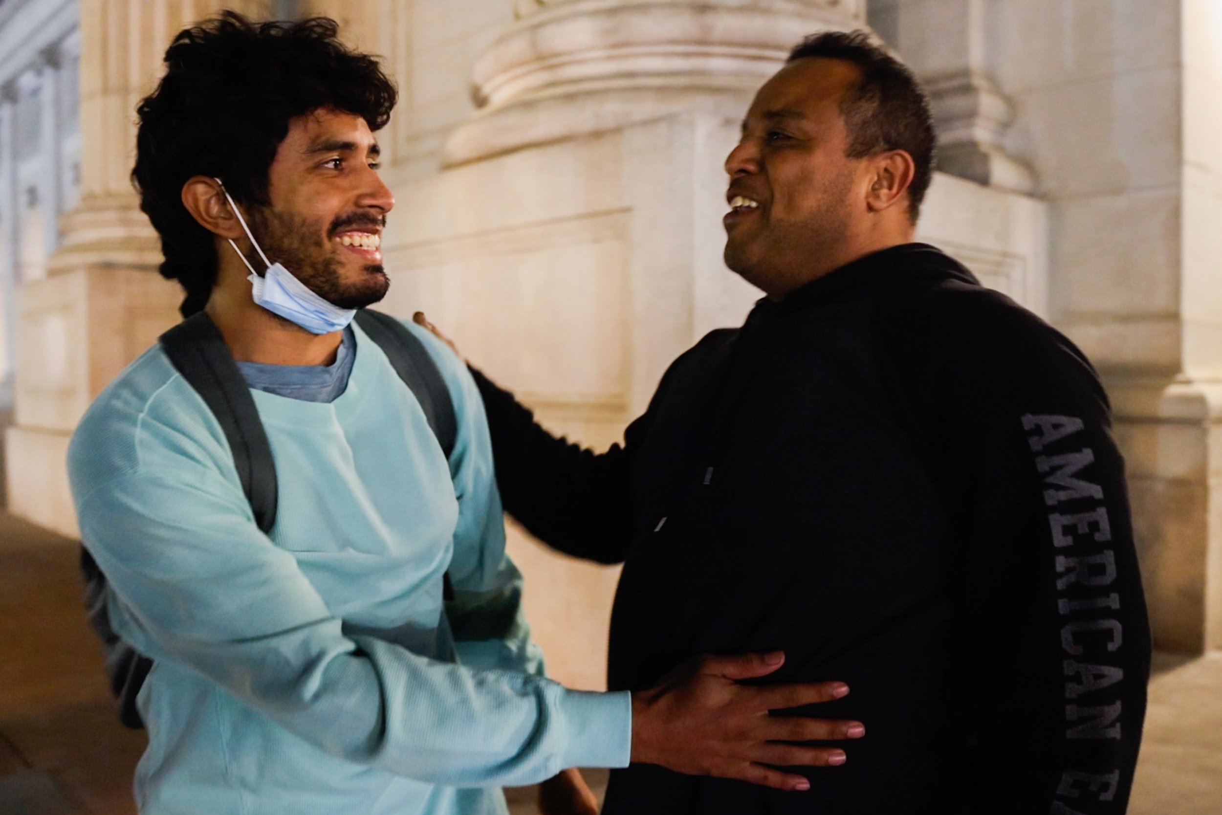  Victor Rodriguez, 26, smiles as Diego Mena, 51, says to him in Spanish "Welcome to the United States" while they meet at the entrance of the Union Station in Washington, D.C. on Thursday, April 21, 2022. Rodriguez, originally from Venezuela, request