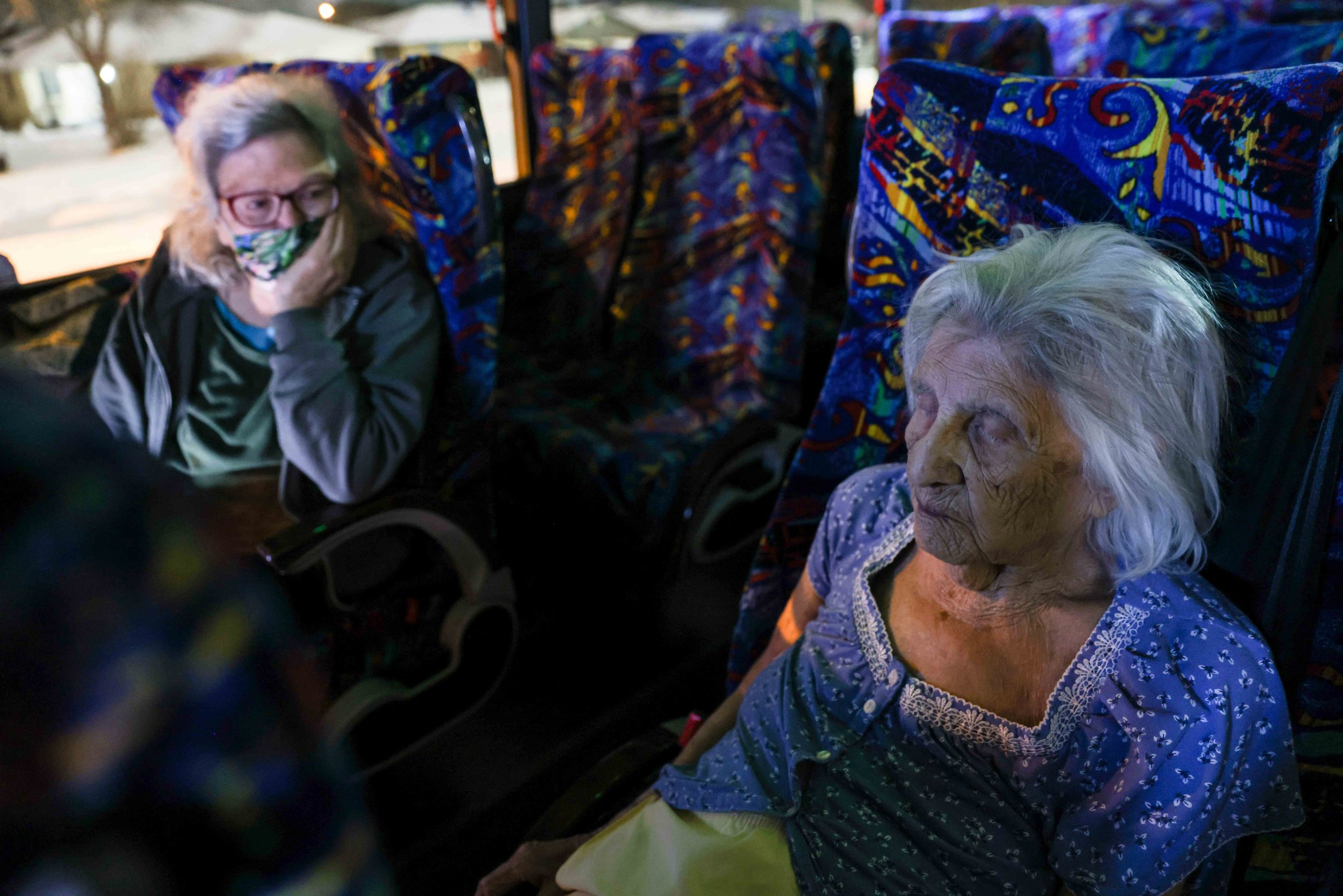  Gloria Sanders, 76, looks at her mother, Maria Barajas, who is 100 years old and suffers from severe dementia, that sleeps sitting on a bus seat that serves as warming center located in Pleasant Oaks Recreation Center in Dallas on Wednesday, Februar