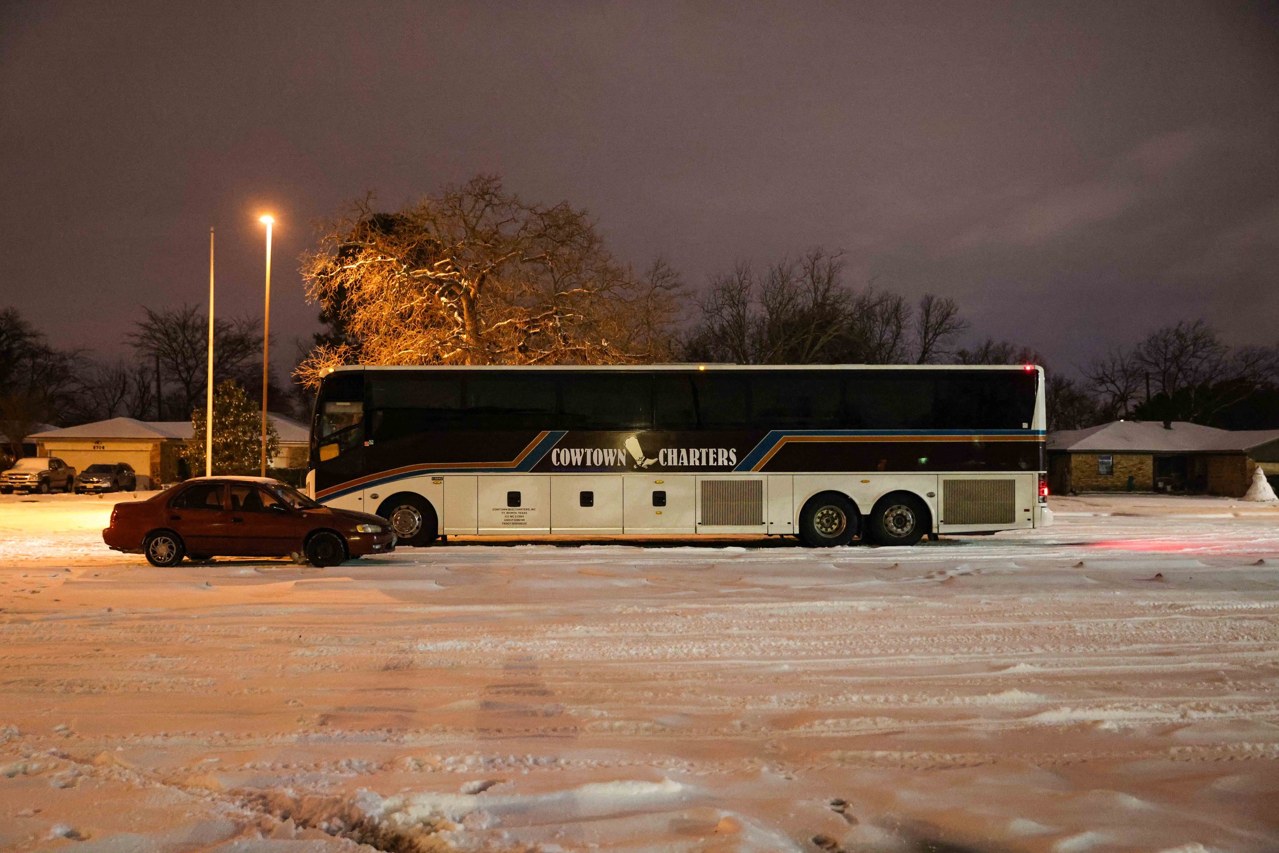  Marleny Almendarez's car is parked next to a charter bus that the local government provided as a warming center for the Pleasant Groves community located in Pleasant Oaks Recreation Center in Dallas on Wednesday, February 18, 2021.  