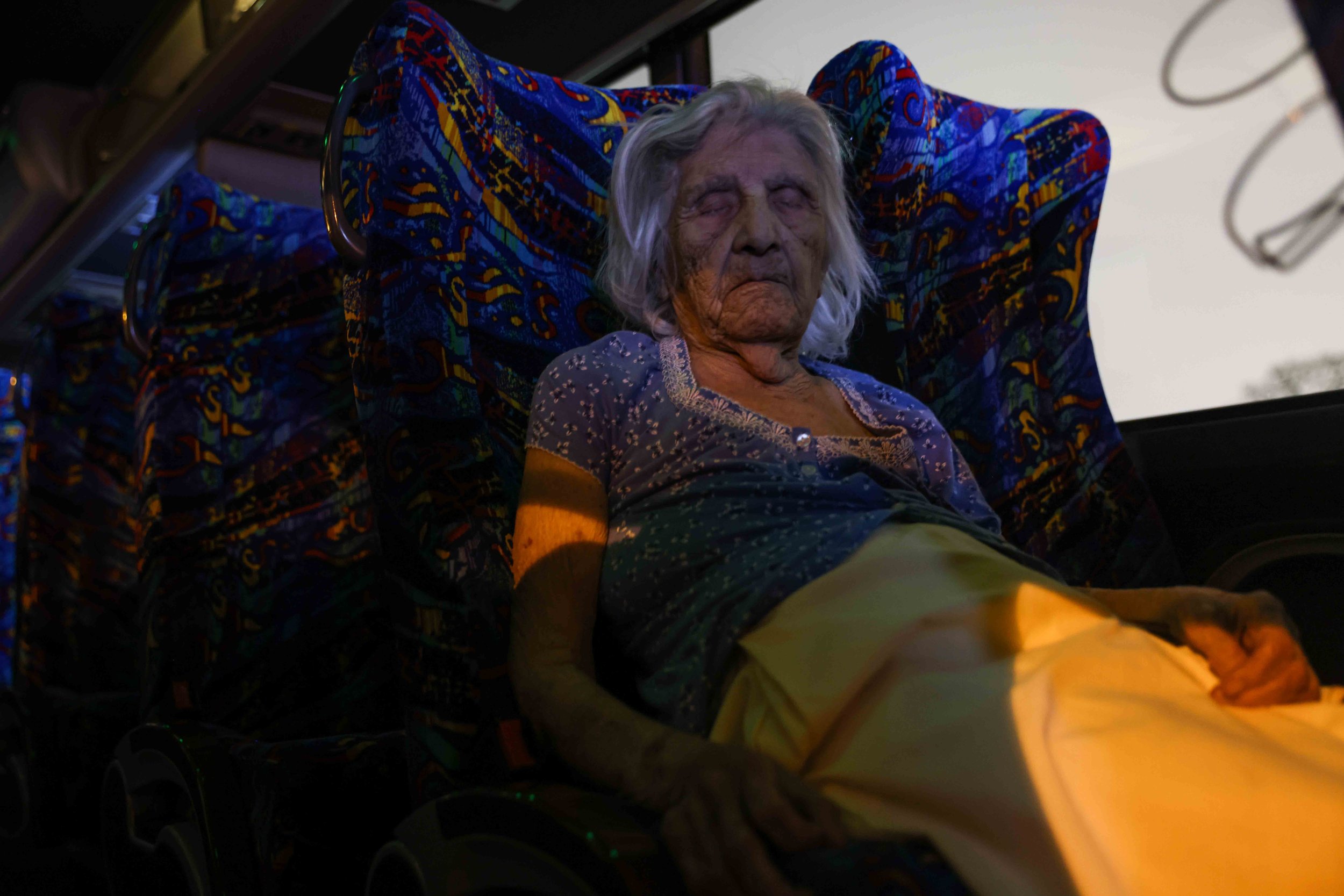  Maria Barajas, who is 100 years old and suffers from severe dementia, sleeps sitting on the bus seat that serves as a warming center located in Pleasant Oaks Recreation Center in Dallas on Wednesday, February 18, 2021. On early Monday, the house she