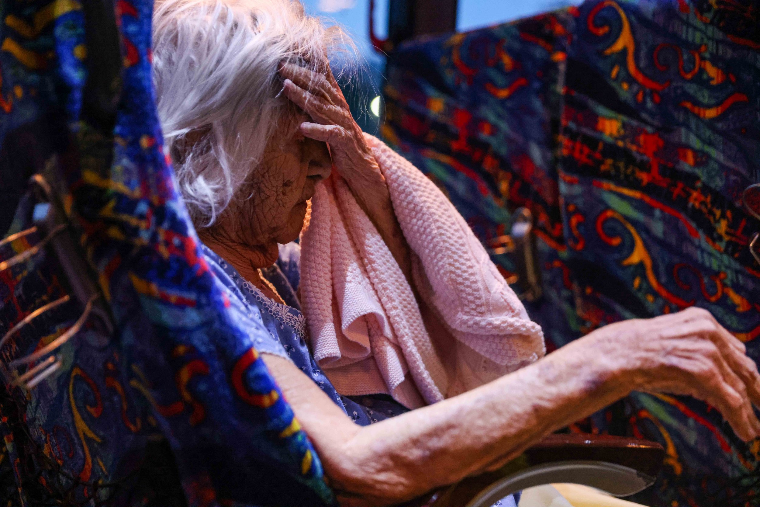  Maria Barajas, who is 100 years old and suffers from severe dementia, prepares to spend the night on the bus that serves as a warming center located in Pleasant Oaks Recreation Center in Dallas on Wednesday, February 18, 2021, after early Monday the