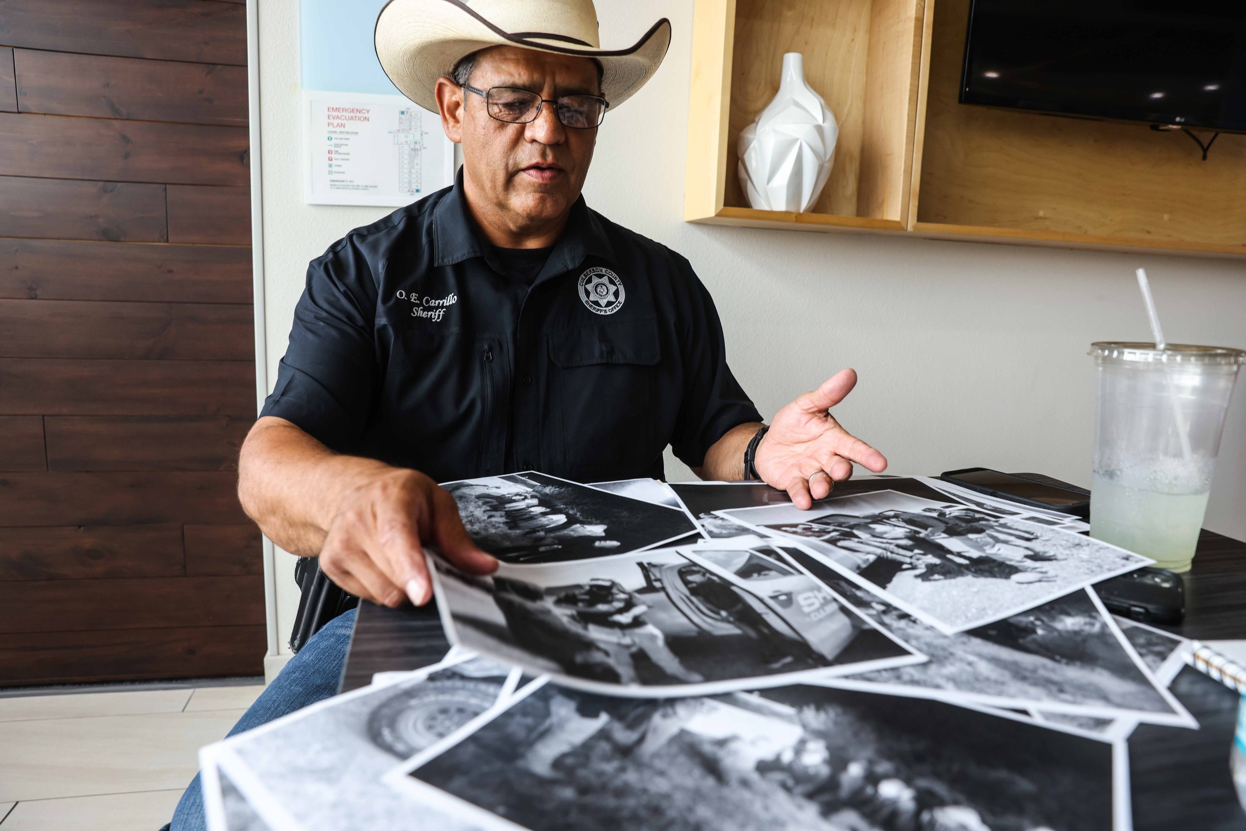  Culberson County Sheriff Oscar Carrillo shows photos of the work his office in Van Horn does answering calls involving unauthorized immigrants crossing the border from Mexico into the United States through his county. 