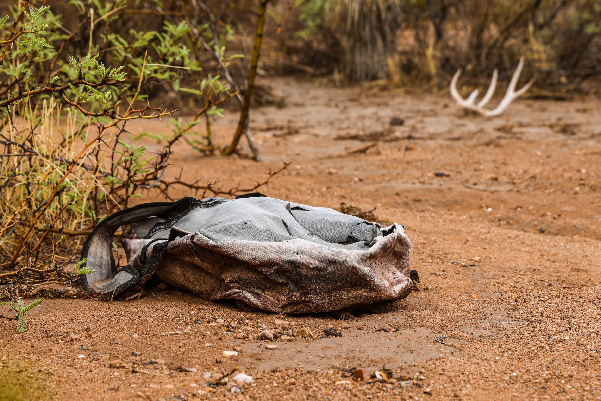  A backpack allegedly abandoned by an undocumented migrant, lies on the ground by the remains of deer antlers near Interstate 10 in Van Horn, Texas in Culberson County on Monday, June 28, 2021. 