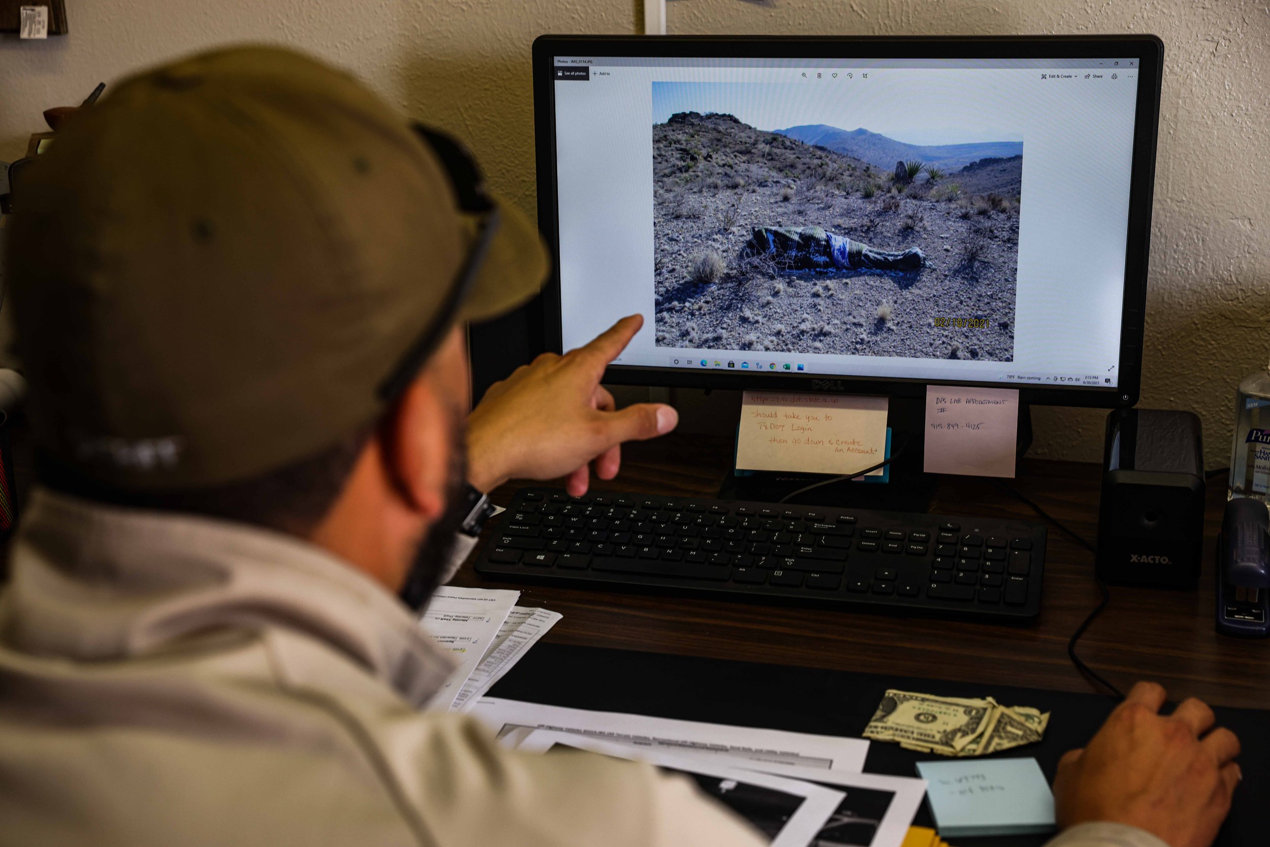  Culberson County Chief Deputy Joseph Corrales shows a photo of the body of an undocumented migrant found in the Texas desert within the vicinity of Culberson County in Van Horn, Texas on Wednesday, June 30, 2021. 