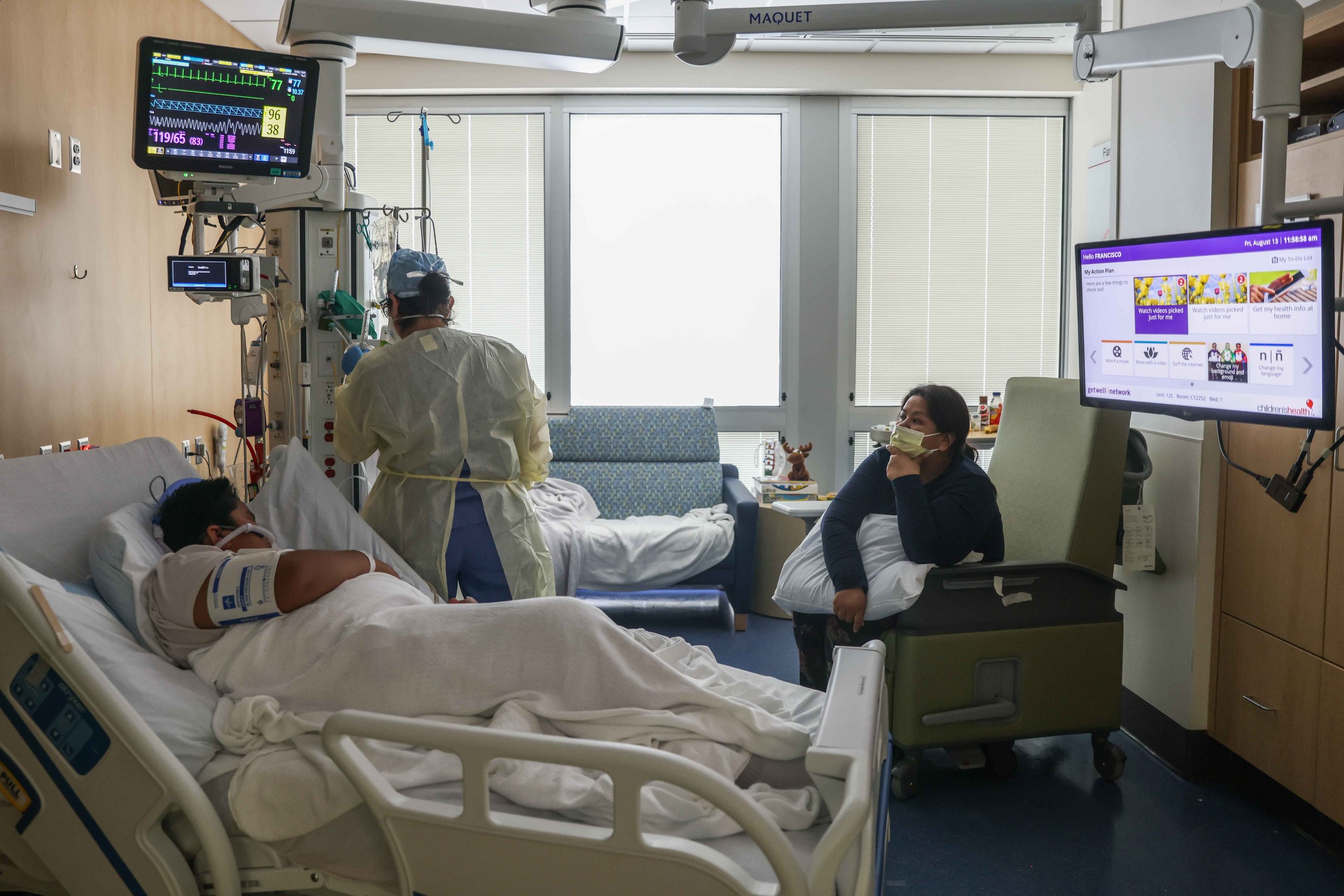  Nurse Christina Walker checks the oxygen flow that is administered on Francisco Rosales, 9, who is being treated as a COVID-19 patient in the pediatric intensive care unit at the Children's Medical Center in Dallas on Friday, August 13, 2021, as Yes