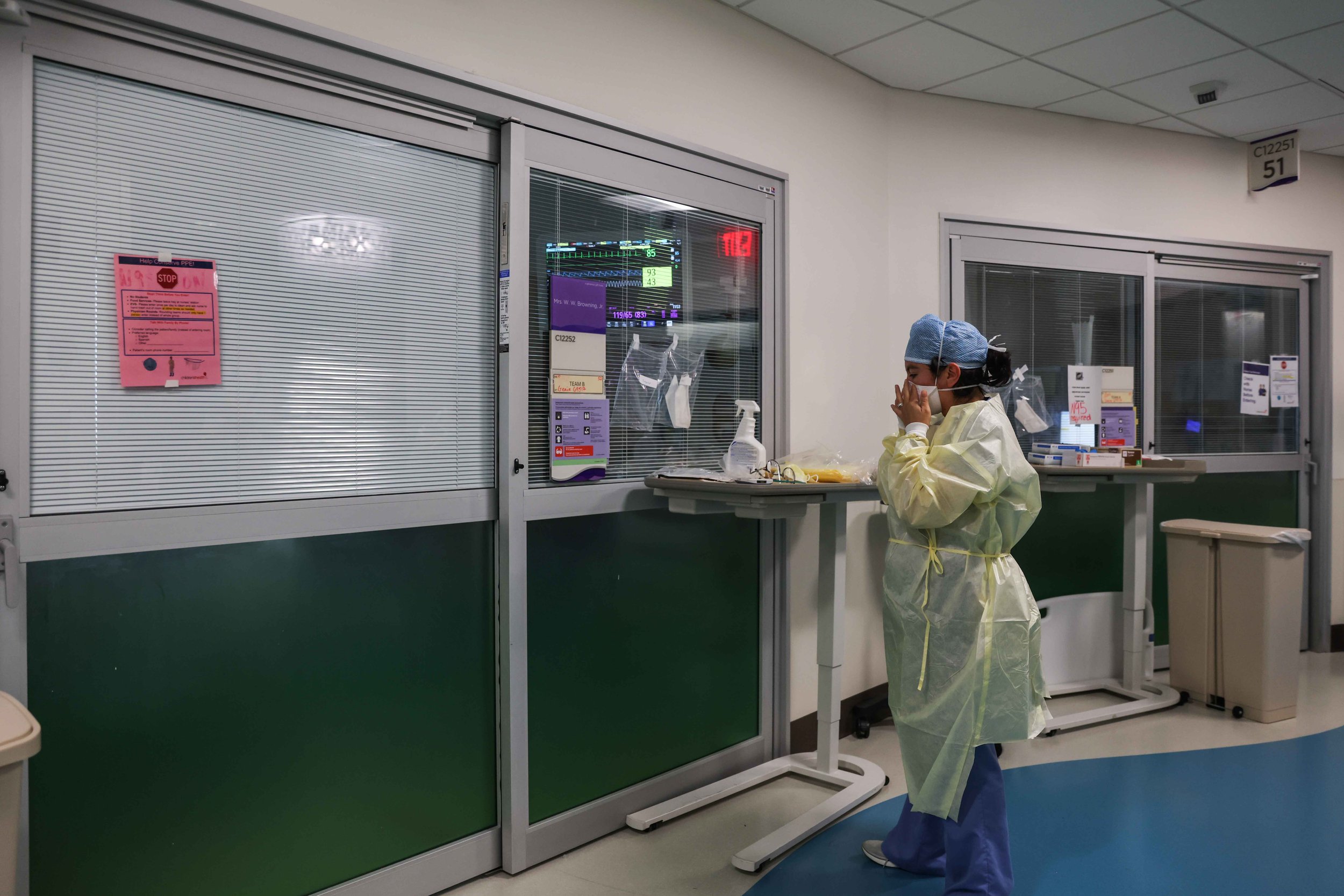  Nurse Christina Walker makes sure a mask properly protects her face before entering the room where Francisco Rosales, 9, is being treated for COVID-19 in the pediatric intensive care unit at Children's Medical Center Dallas on Friday, Aug. 13, 2021.