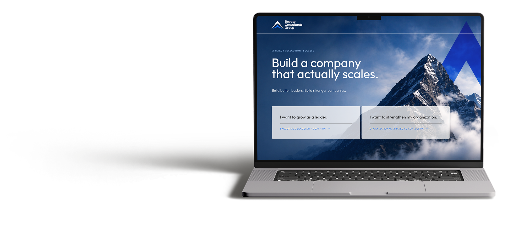 Open laptop displaying a webpage from Elevate Consultants Group with a mountain background, the headline 'Build a company that actually scales,' and options to learn about leadership coaching and organizational strategy.