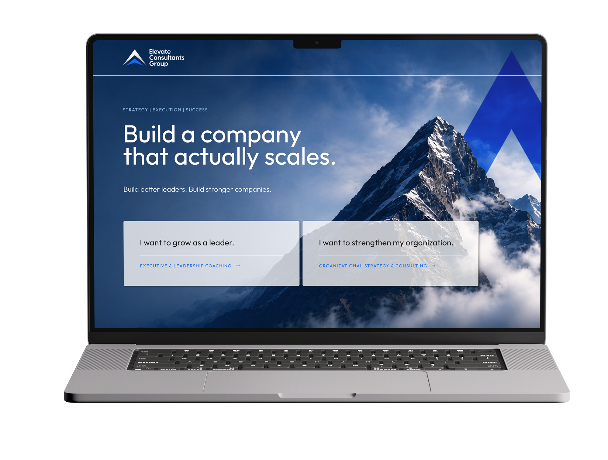 Laptop displaying a website with a mountain and business coaching services.