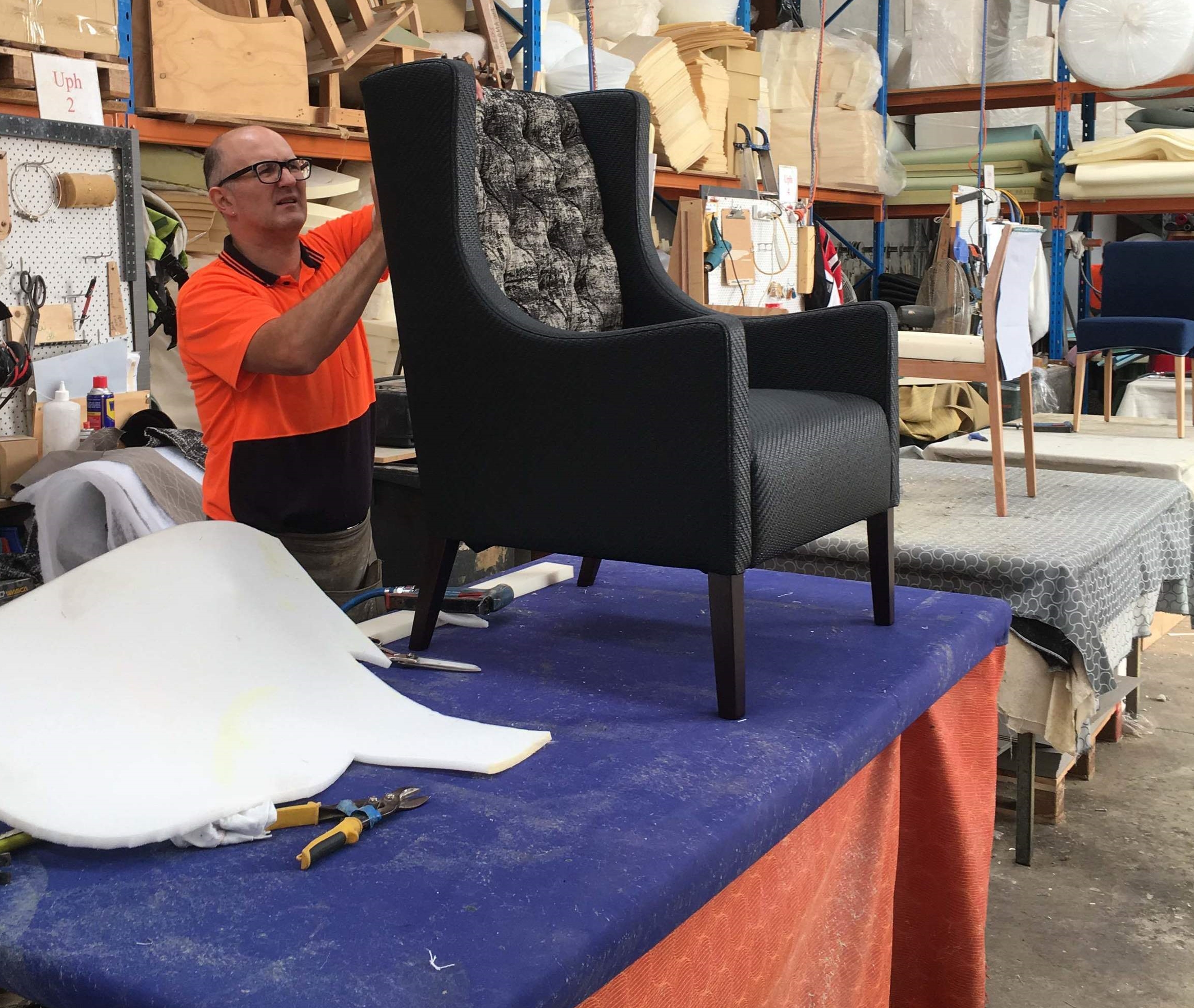 Matteo, one of our upholsterers finishing off a diamond buttoned armchair