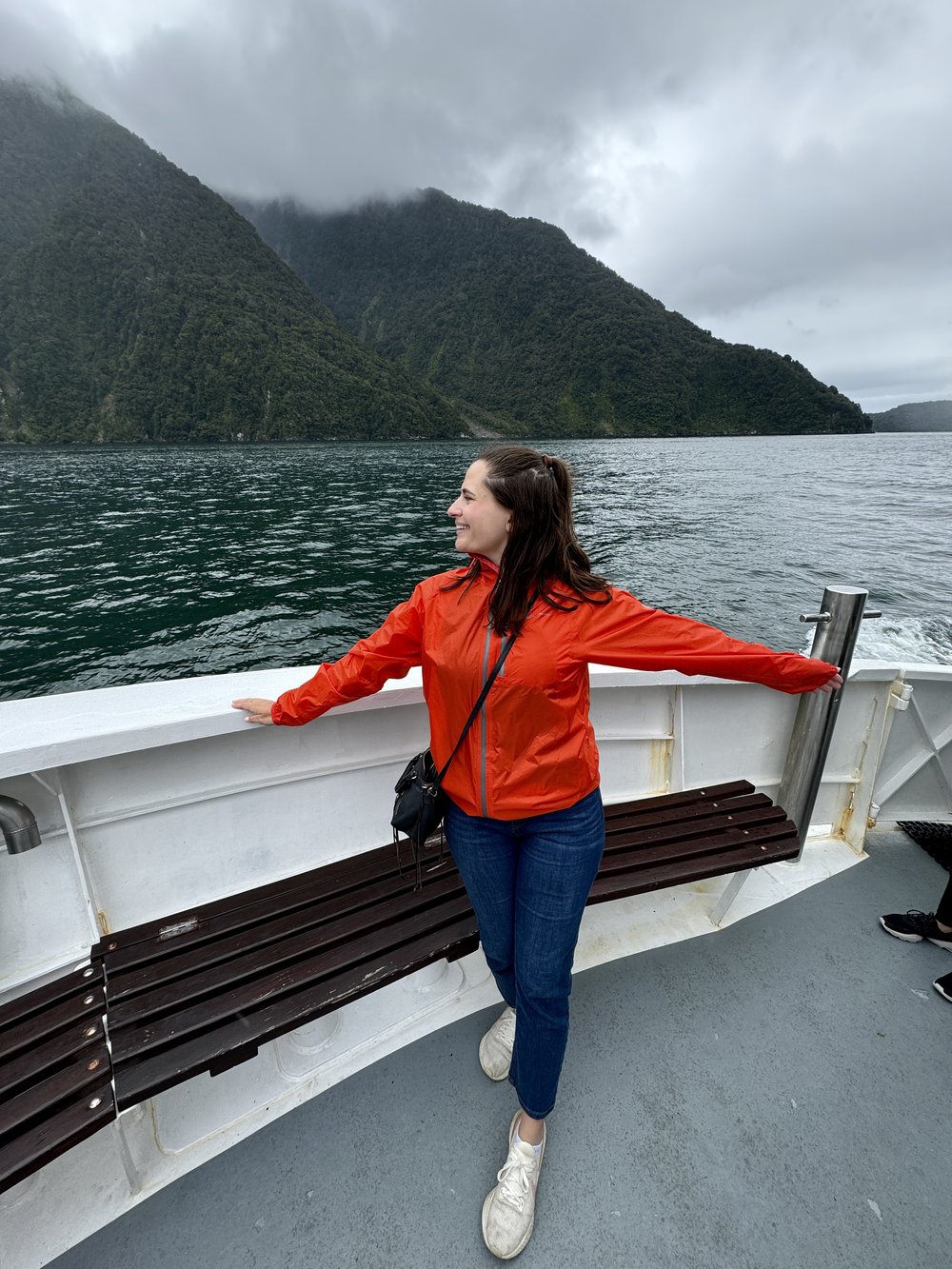 Keep Calm and Chiffon Blogger Austen Tosone in a boat and sharing New Zealand Travel Tips 2024