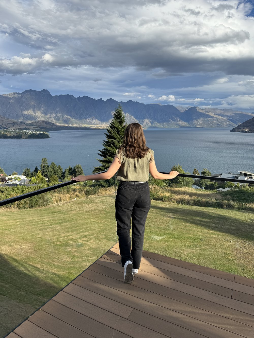Keep Calm and Chiffon Blogger Austen Tosone looking at a view and sharing New Zealand Travel Tips 2024