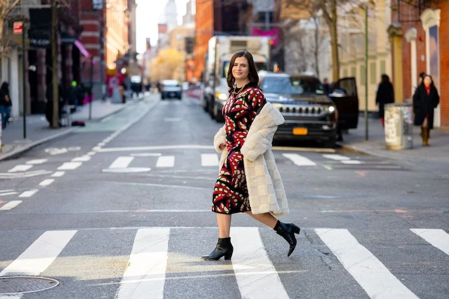Tips For Balancing Organic and Sponsored Content Austen Tosone in a white coat and dress walks through a city street symbolizing "Tips For Balancing Organic and Sponsored Content"