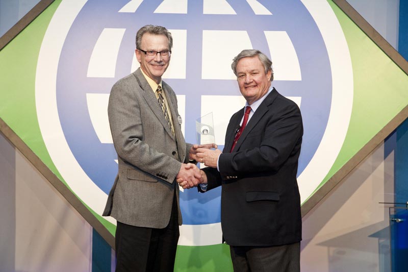 John Crabtree (left), NCI Assistant Director, accepts the Service to Exporters Award from Governor Jack Dalrymple, (right), who presented it on behalf of the North Dakota Trade Office (NDTO).