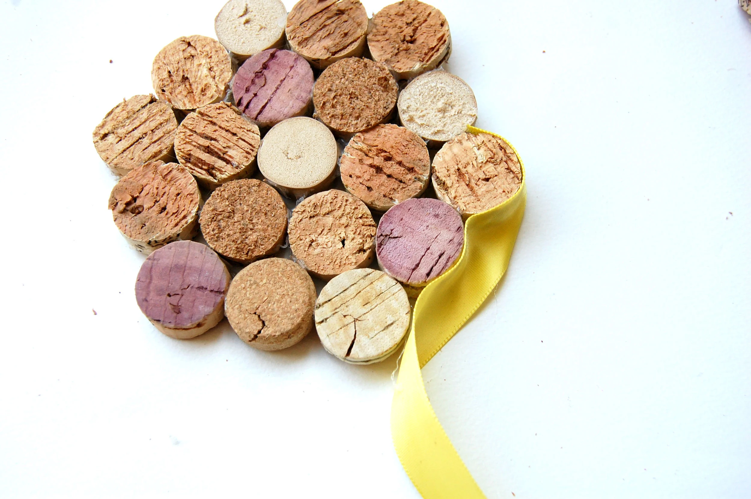 Gluing ribbon one cork piece at a time