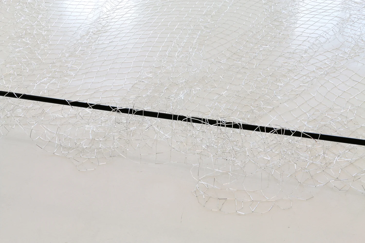 Wavelans / jharjhar , 2019, glass bugle beads, nylon thread, 500 x 700cm
