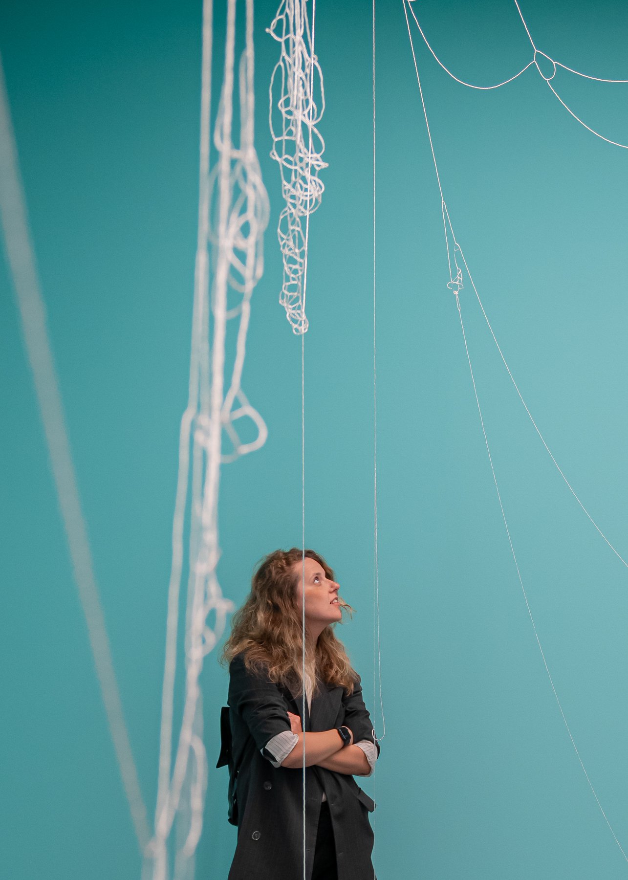  Making Waves   Installation with ‘Atoms of Delight’ (glass beads and nylon thread), ‘Small Fires’(nails and magnets) and wall paint  at Bündner Kunstmuseum, Chur Fotocredit: Yanik Bürkli, on the picture: Anna Konstantinova   