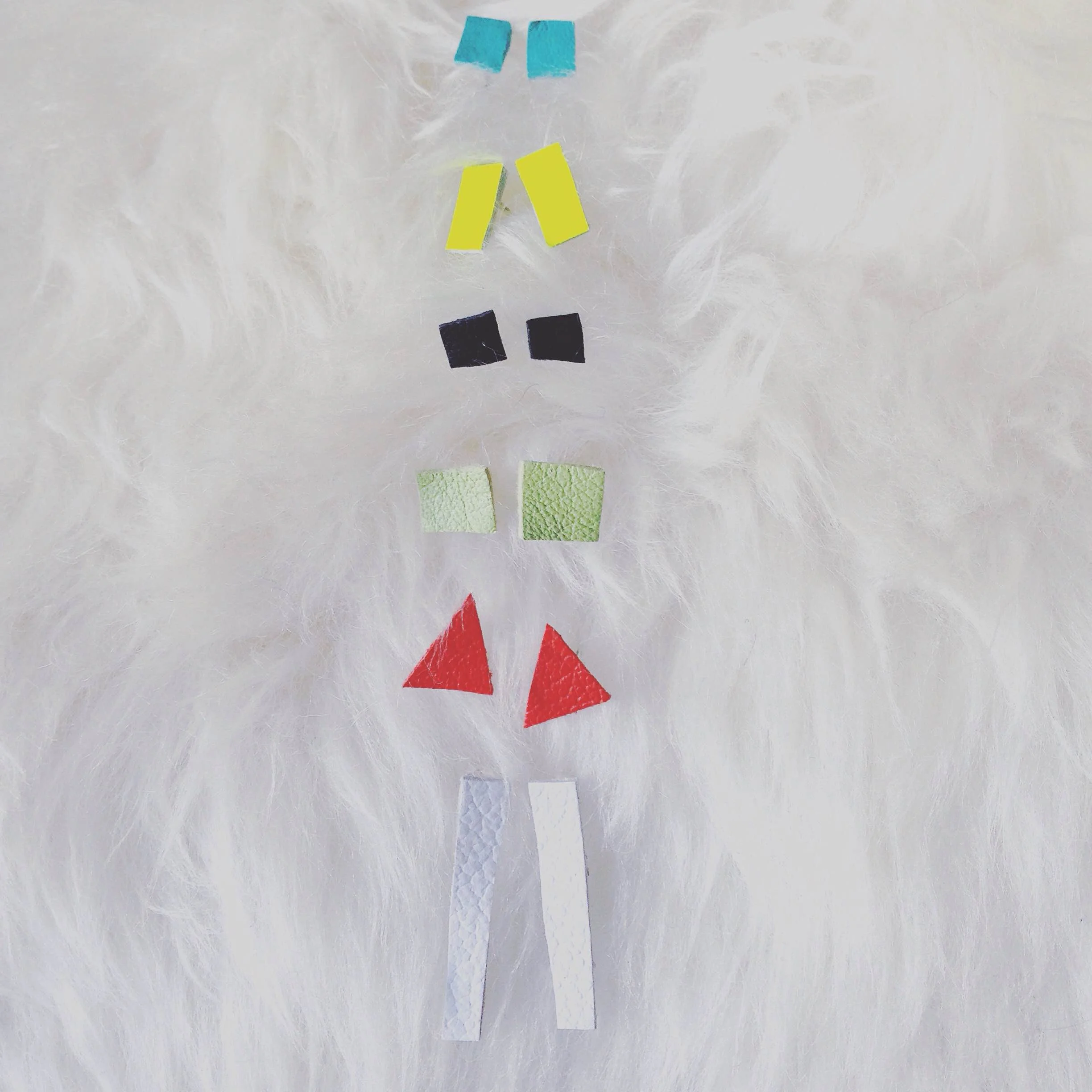  Hand-cut repurposed leather earrings on surgical stainless posts with butterfly closures. The leather is from high-end bag makers in San Francisco. 