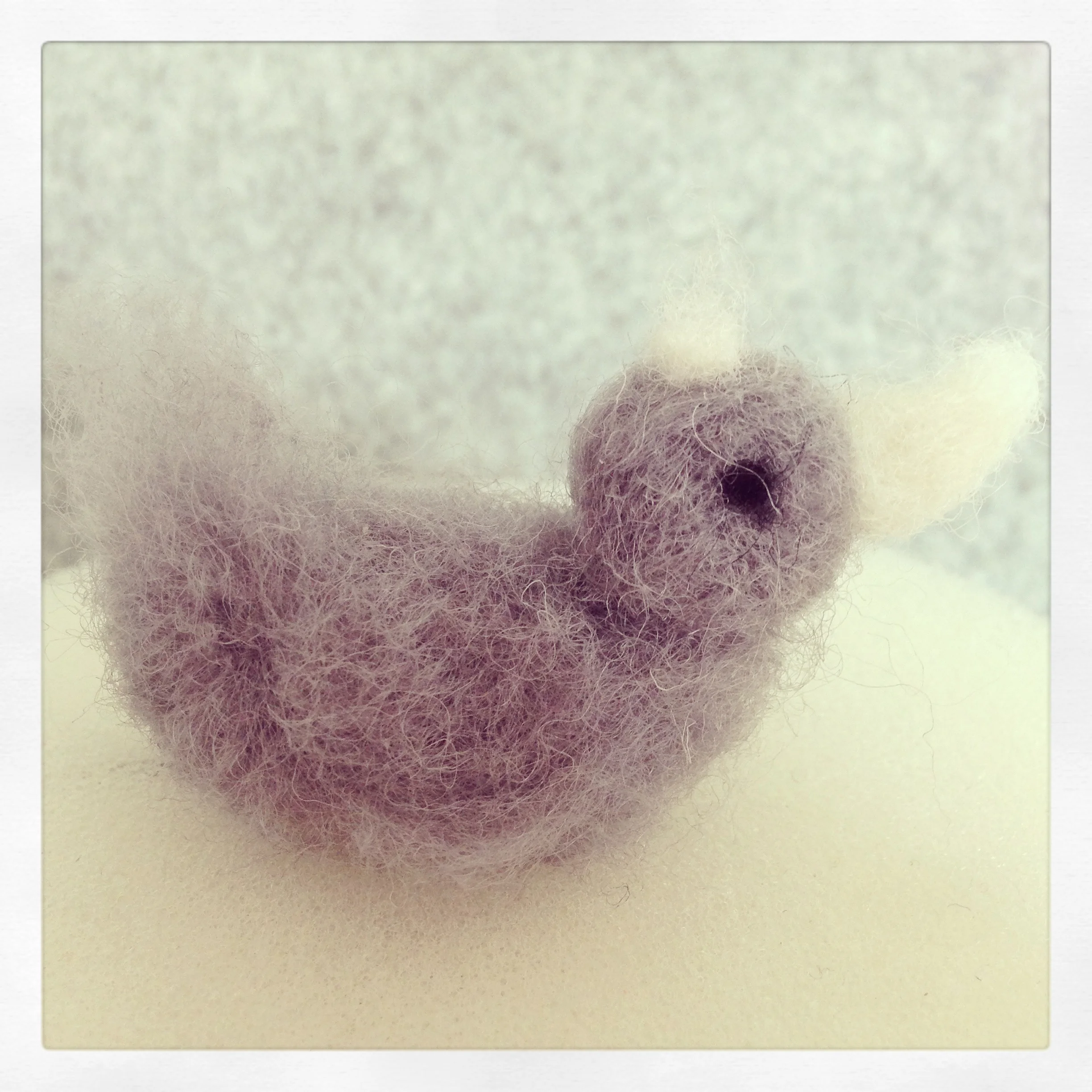 Astrid's first felting attempt. A little fluffy duck :)