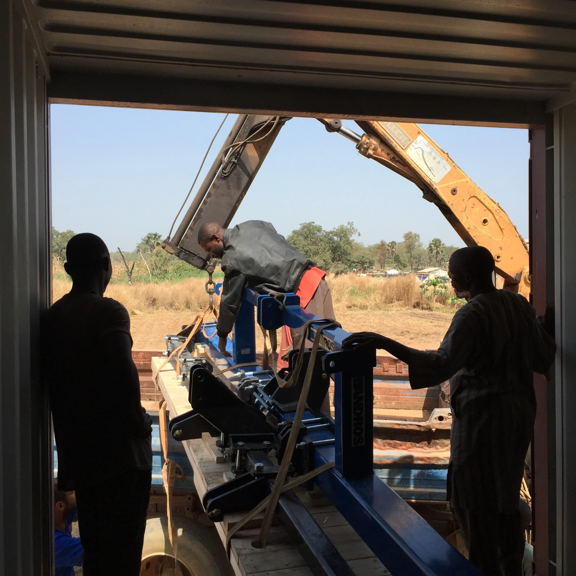 The farming team unloads one of our imported tractor implements
